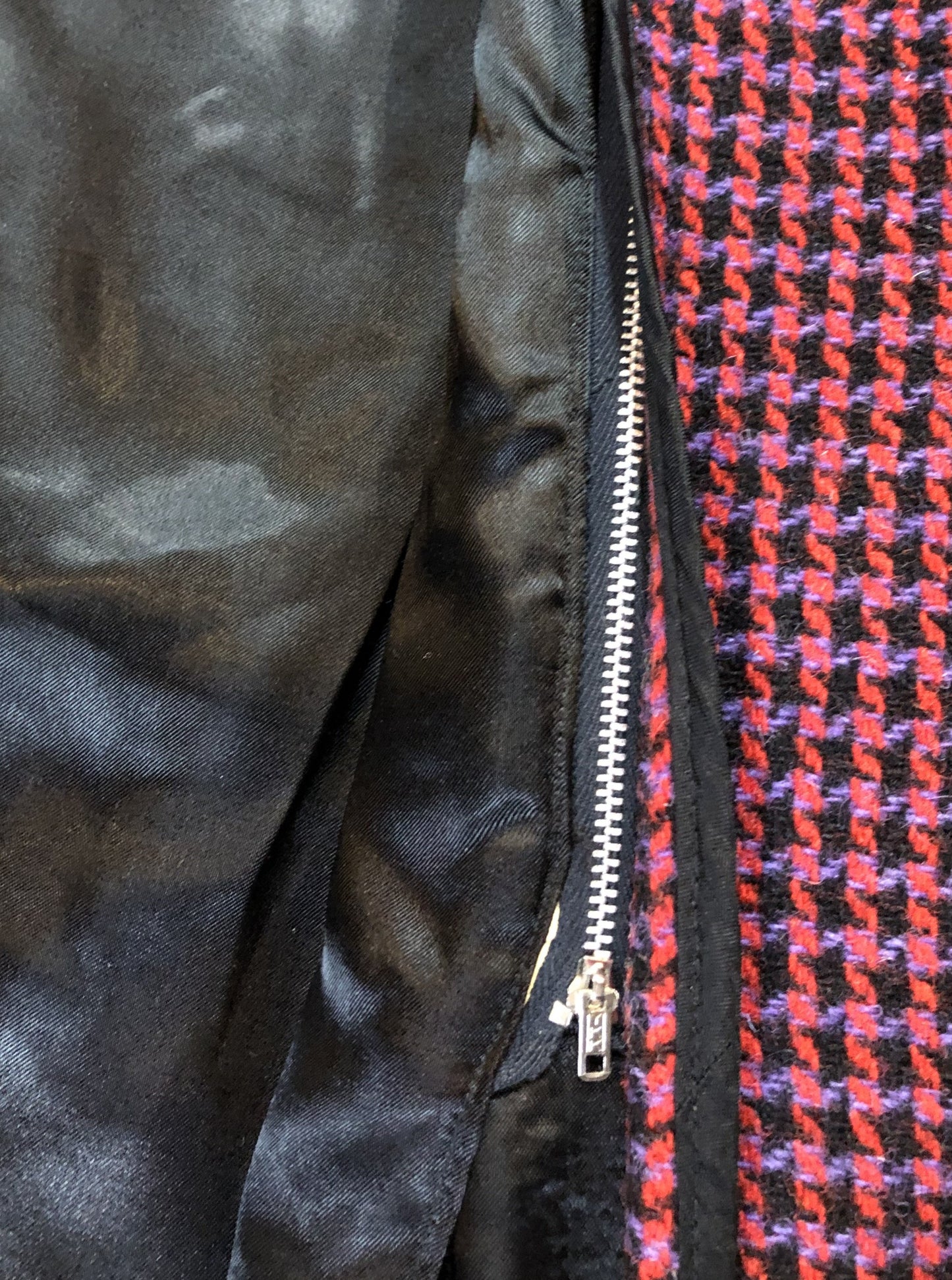 Kingspier Vintage - Mills Brothers red, black and blue houndstooth wool coat. The colours in the houndstooth come together to make a deep purple. This coat features button closures, vertical pockets, knit inner cuffs, a satin lining and zip out genuine chamois inner- lining. Made in Canada. Size medium/ large.