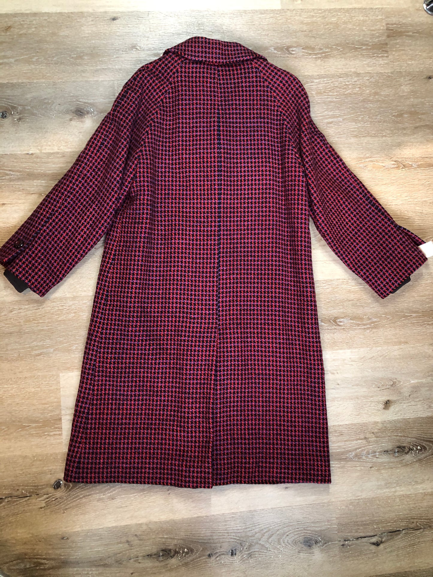 Kingspier Vintage - Mills Brothers red, black and blue houndstooth wool coat. The colours in the houndstooth come together to make a deep purple. This coat features button closures, vertical pockets, knit inner cuffs, a satin lining and zip out genuine chamois inner- lining. Made in Canada. Size medium/ large.