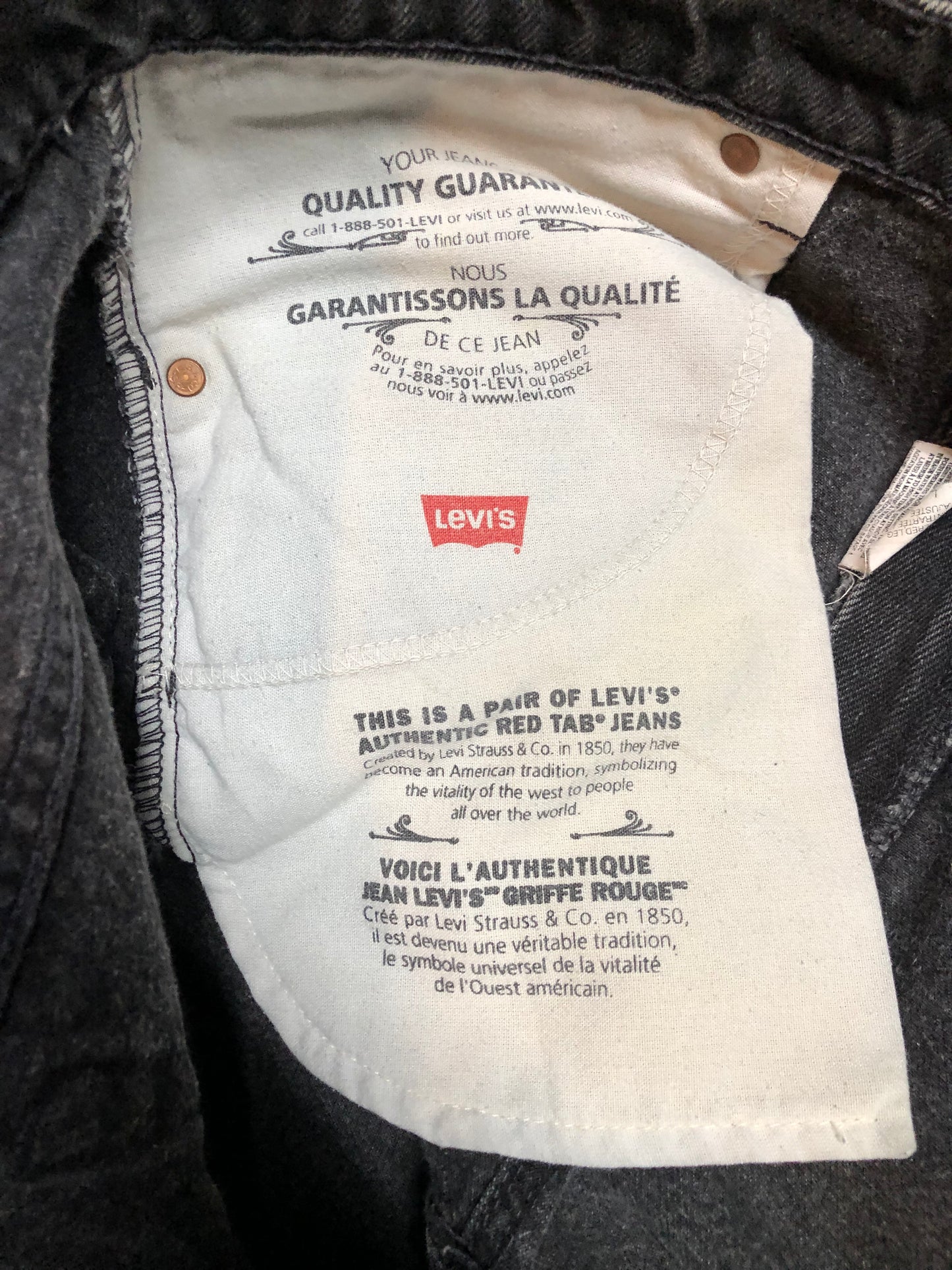 Levi’s 550 - 36”x28” Black Denim Jeans Vintage Red Tab High rise Button fly Tapered leg Tagged 36”x30” 100% Cotton Button stamped “217” Made in Canada - Kingspier Vintage