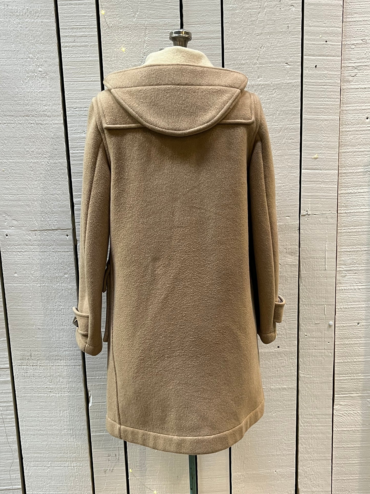 Vintage Gloverall tan duffle coat, with zipper and antler toggle closures, hood and two flap pockets.
80% wool/ 20% polyester
Made in England
Size 40