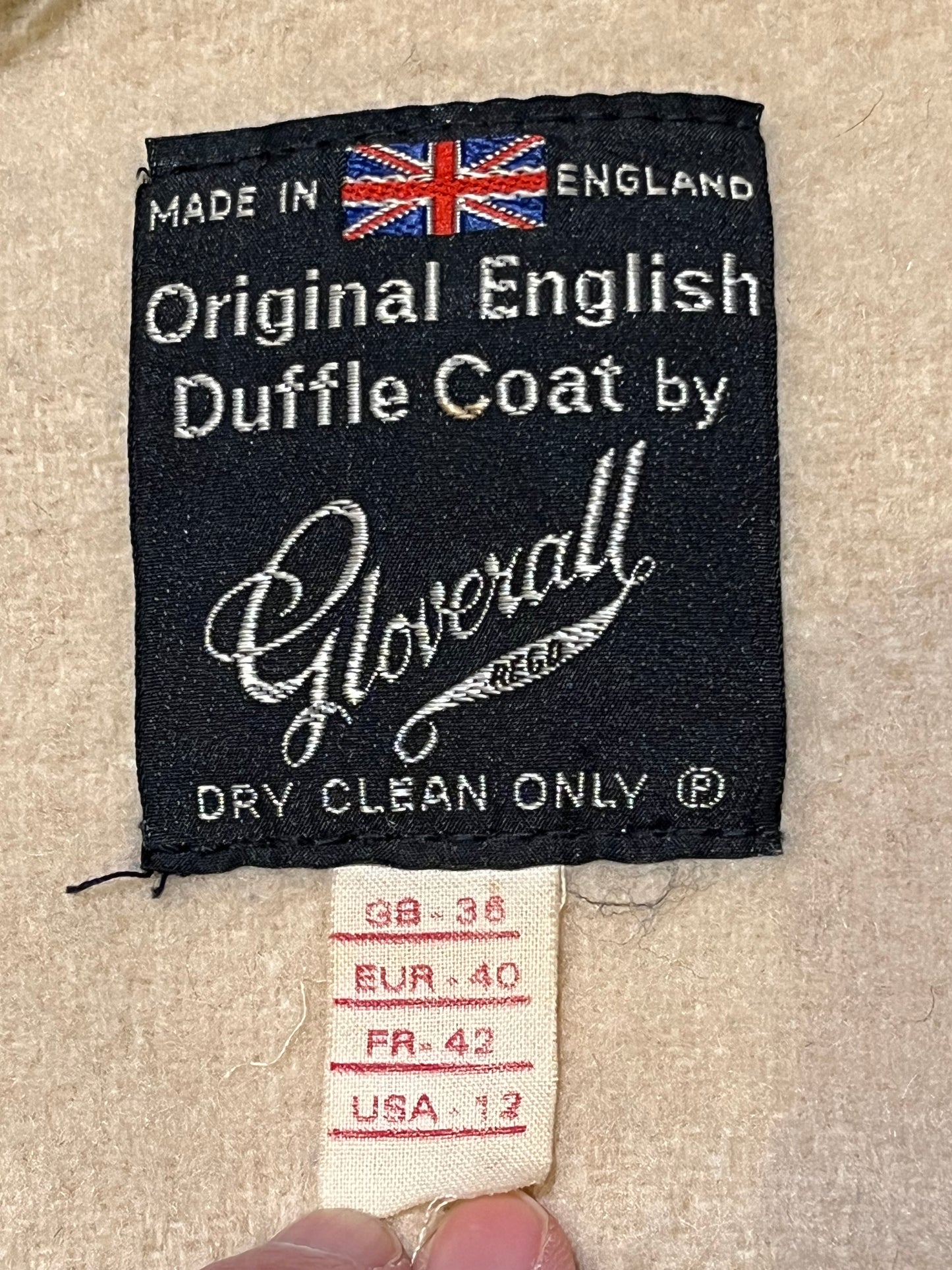 Vintage Gloverall tan duffle coat, with zipper and antler toggle closures, hood and two flap pockets.
80% wool/ 20% polyester
Made in England
Size 40