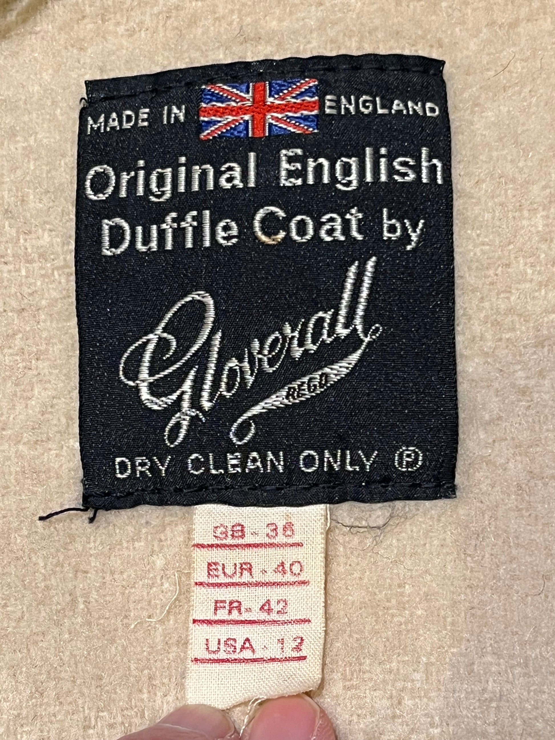 Vintage Gloverall tan duffle coat, with zipper and antler toggle closures, hood and two flap pockets.
80% wool/ 20% polyester
Made in England
Size 40