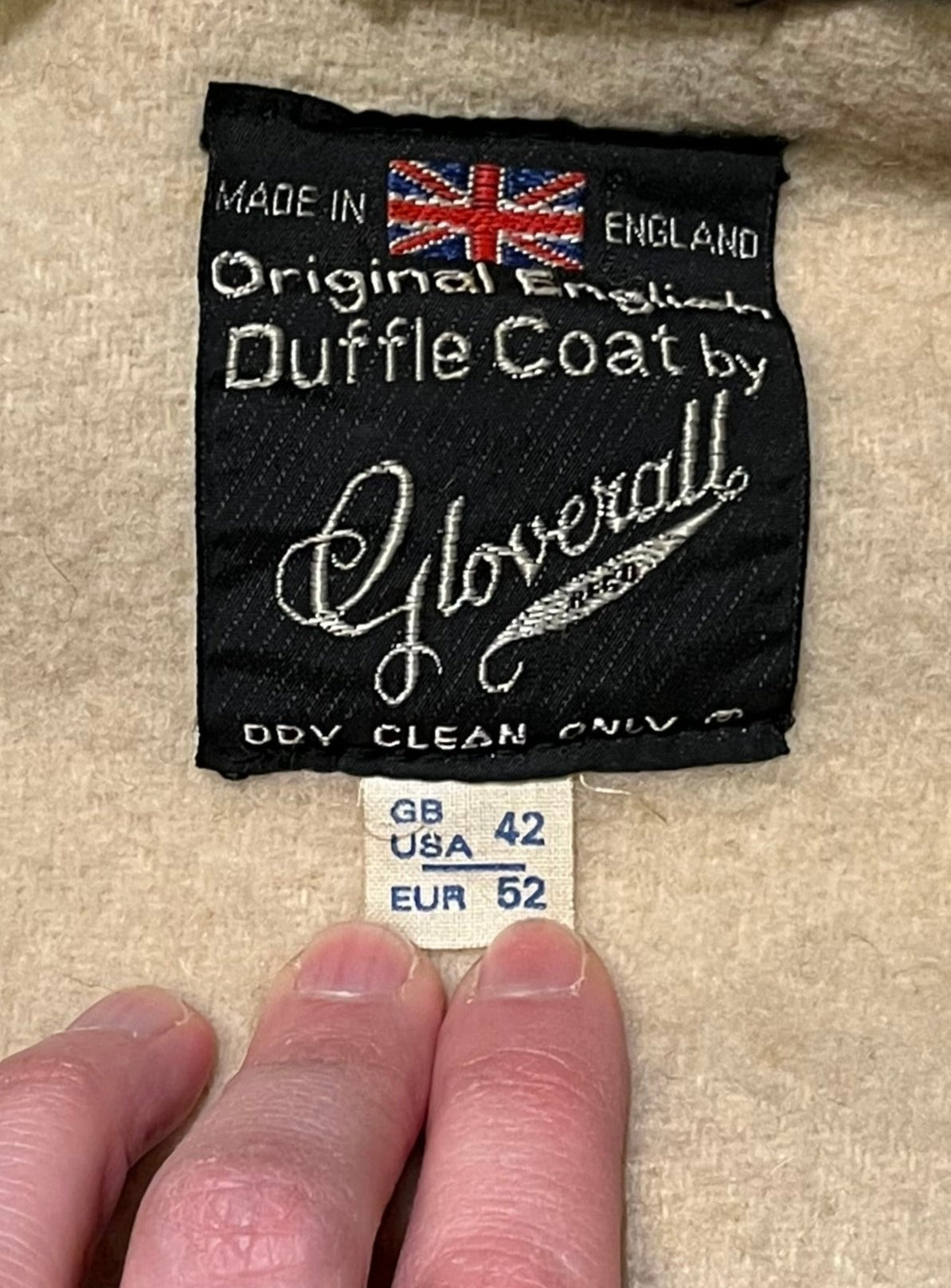 Vintage Gloverall tan duffle coat, with zipper and horn toggle closures, hood and two flap pockets.
80% wool/ 20% polyester
Made in England
Size 52