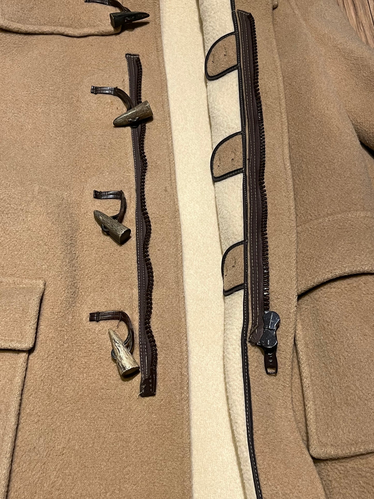 Vintage Gloverall tan duffle coat, with zipper and horn toggle closures, hood and two flap pockets.
80% wool/ 20% polyester
Made in England
Size 52