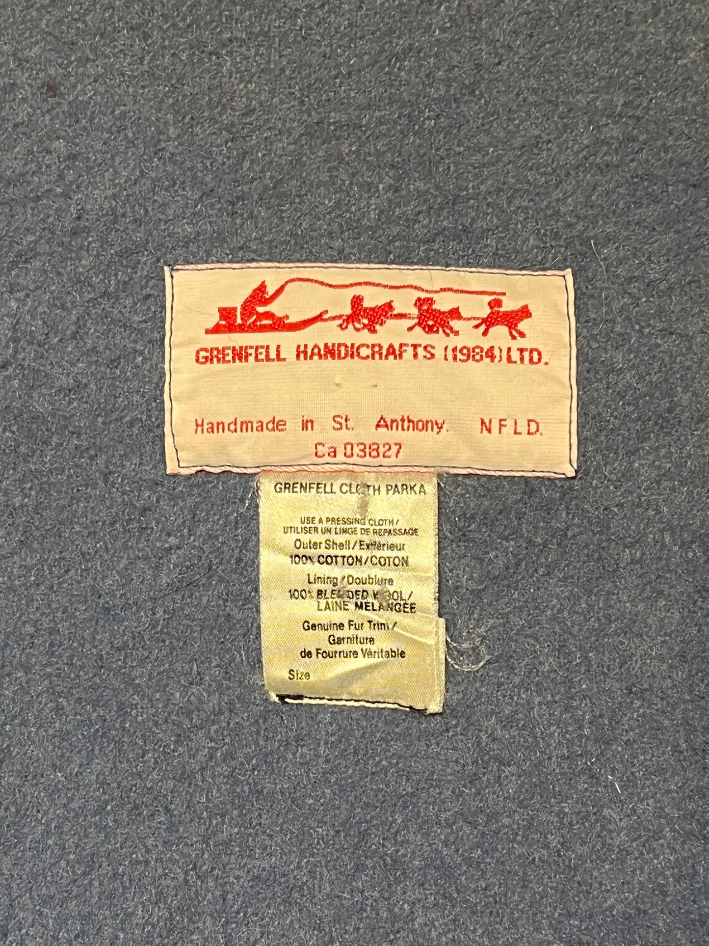 Vintage 80’s Grenfell Handicrafts navy blue northern parka with 100% cotton shell, wool lining,zipper closure,two patch pockets, fur trimmed hood and hand embroidered snowshoeing details.
Handmade in Canada
Chest 54”