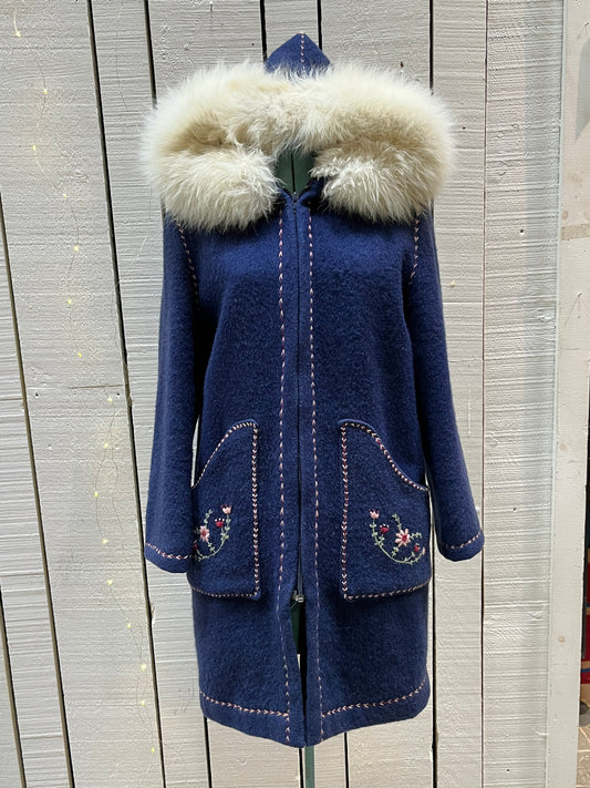 Vintage blue wool northern parka with zipper closures, two patch pockets, white fur trimmed hood, hand embroidered flower details and an embroidered bird on the back. 
Chest 42”