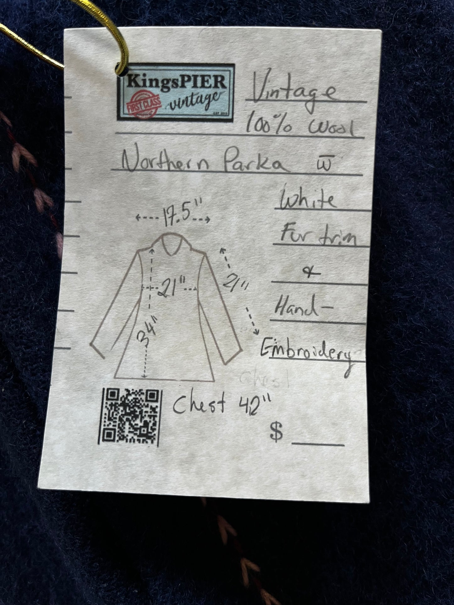 Vintage blue wool northern parka with zipper closures, two patch pockets, white fur trimmed hood, hand embroidered flower details and an embroidered bird on the back.
Chest 42”