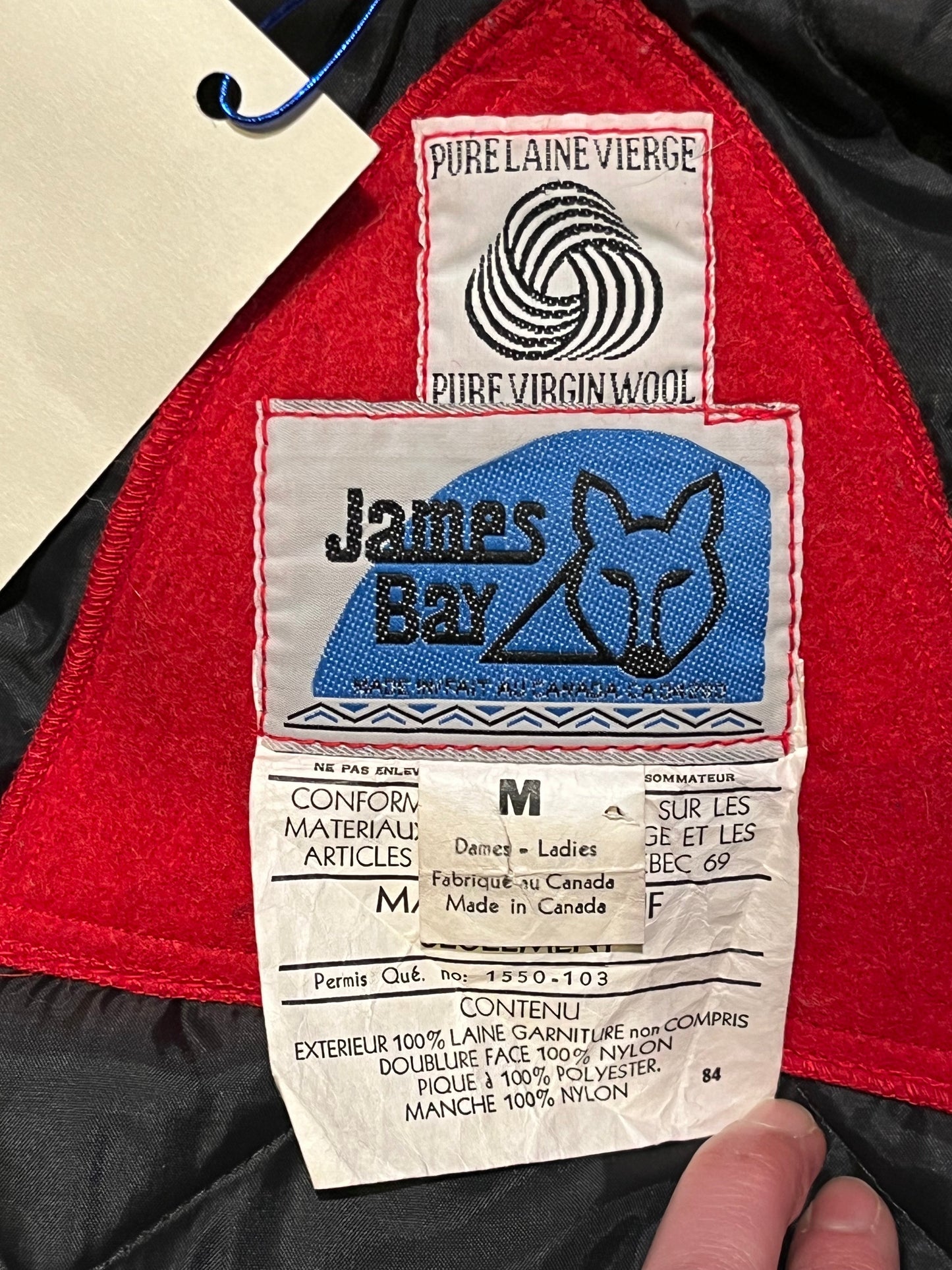 Vintage James Bay 100% pure virgin wool red northern parka with white fur trimmed hood, zipper and snap closures, two zip front pockets, drawstring at the waist, leather trimmed cuffs, a quilted lining and felt applique details.
Made in Canada
Chest 40”