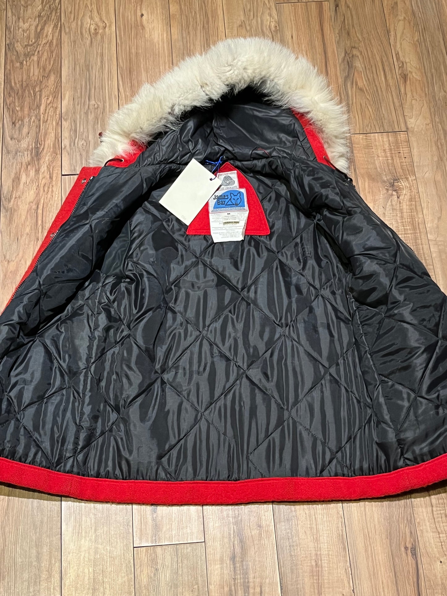 Vintage James Bay 100% pure virgin wool red northern parka with white fur trimmed hood, zipper and snap closures, two zip front pockets, drawstring at the waist, leather trimmed cuffs, a quilted lining and felt applique details.
Made in Canada
Chest 40”