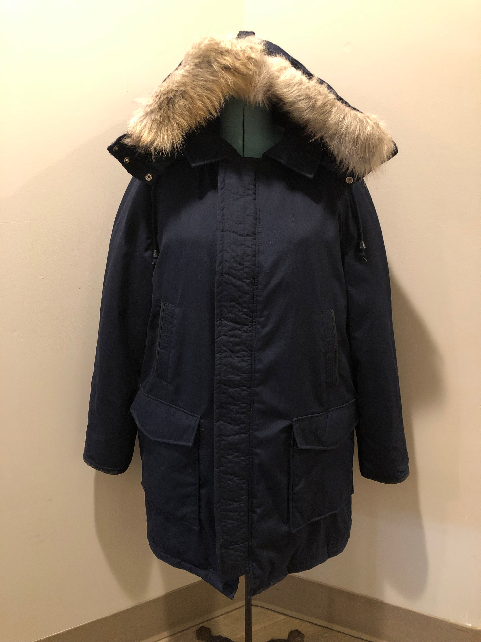 Kingspier Vintage - Vintage down filled cold weather parka in black with no labels.
This parka features a hood with coyote fur trim, quilted lining, storm cuffs, hand warmer pockets and flap pockets, zipper closure, polyester/ cotton shell with 60% down/ 40% waterfowl feather fill.
Made in Korea.
Size 42.