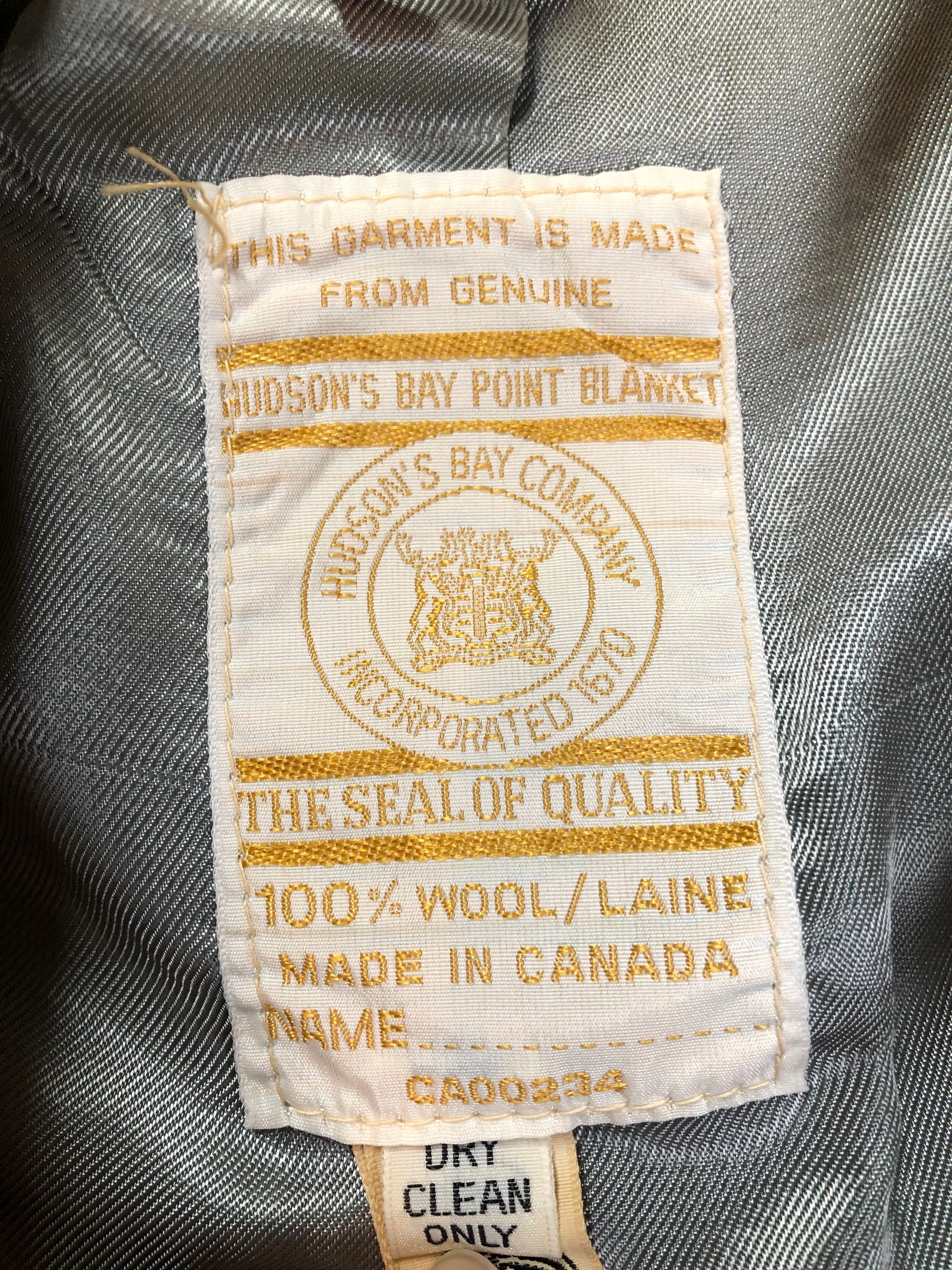 Kingspier Vintage - Genuine Hudson’s Bay Company point blanket coat in the iconic multistripe colours. The coat features flap pockets and hand warmer pockets, double breasted button closures and belt. Made in Canada. Men’s size 46.
