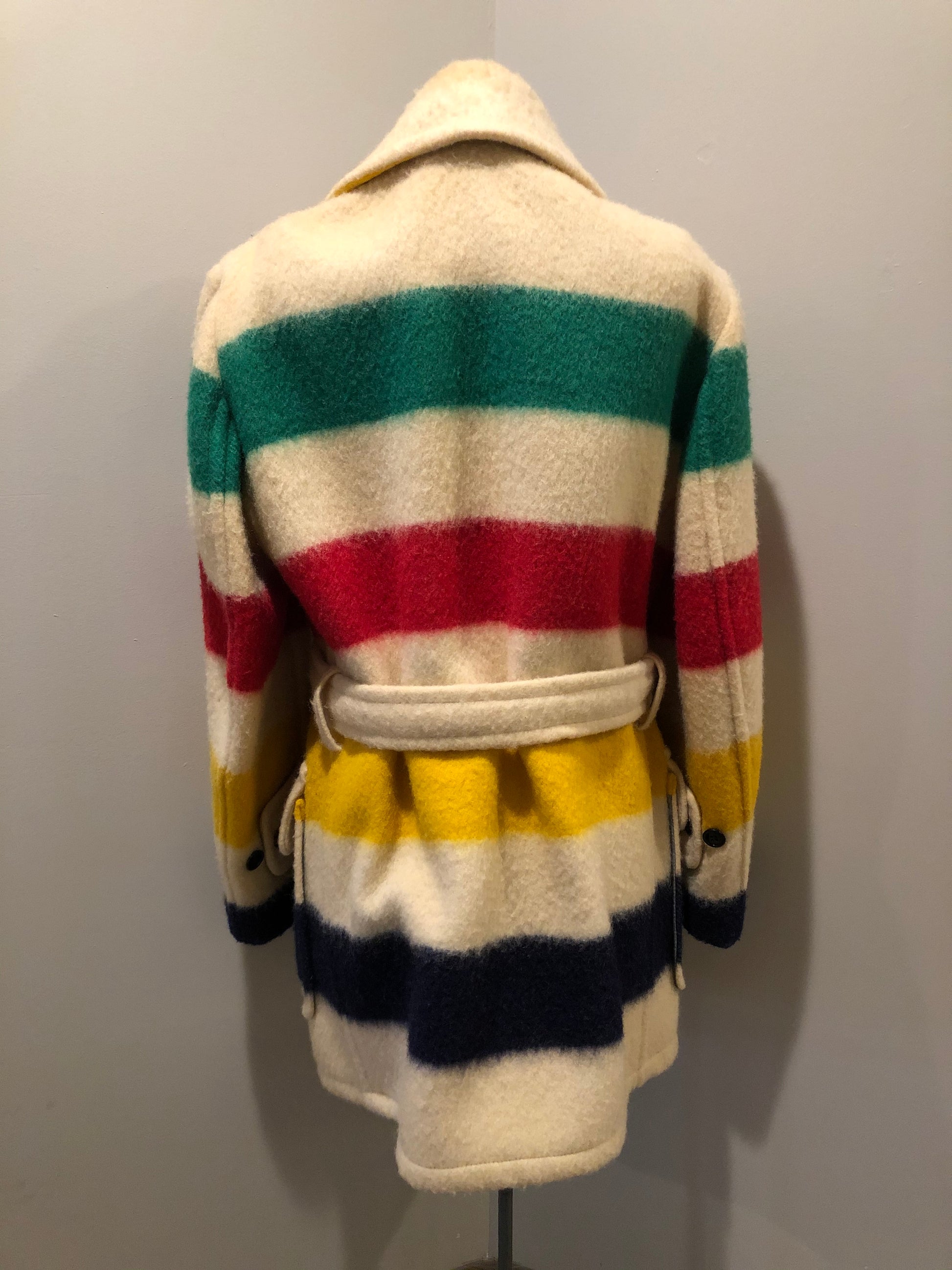 Kingspier Vintage - Genuine Hudson’s Bay Company point blanket coat in the iconic multistripe colours. The coat features flap pockets and hand warmer pockets, double breasted button closures and belt. Made in Canada. Men’s size 46.