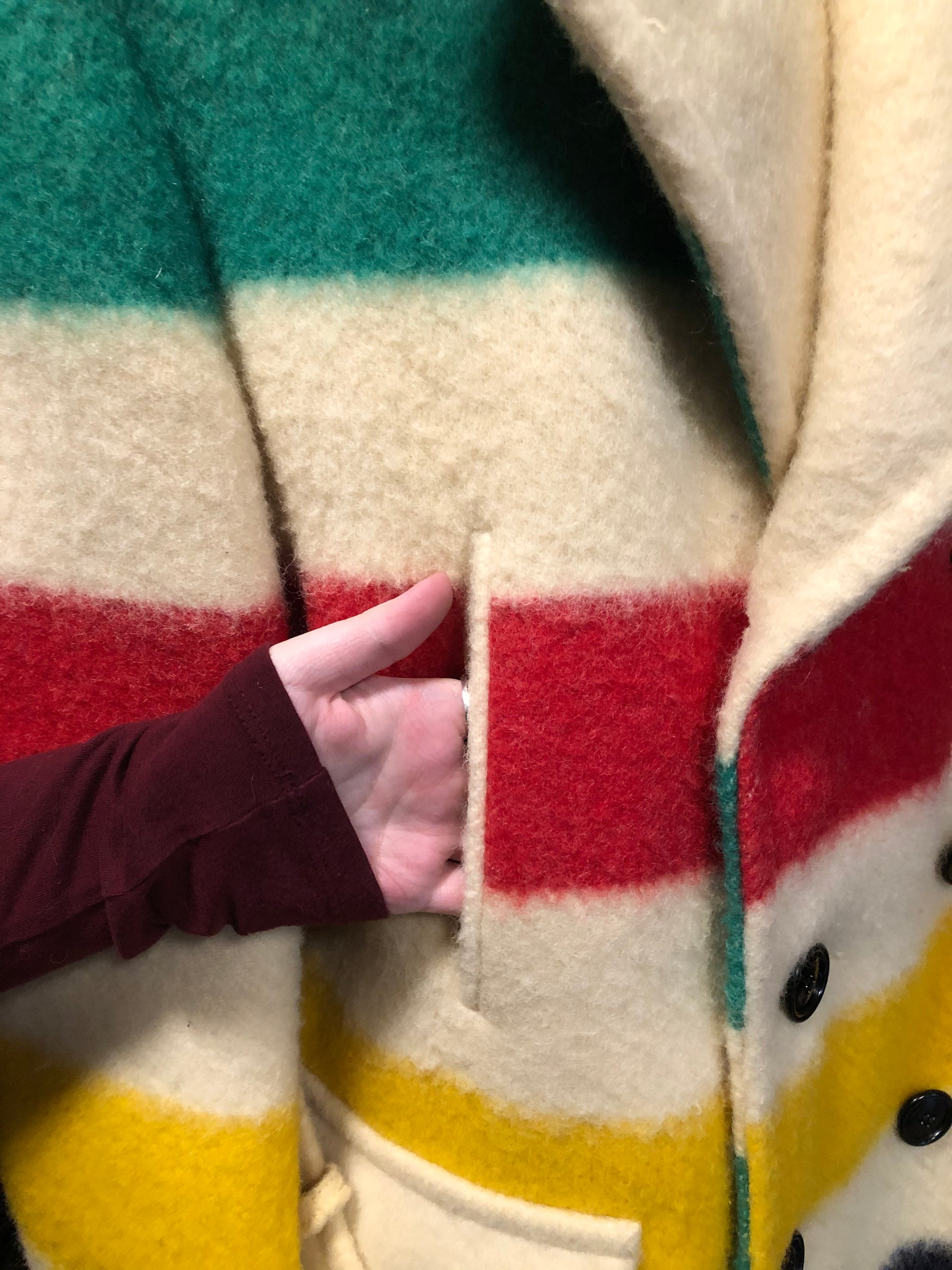 Kingspier Vintage - Genuine Hudson’s Bay Company point blanket coat in the iconic multistripe colours. The coat features flap pockets and hand warmer pockets, double breasted button closures and belt. Made in Canada. Men’s size 46.