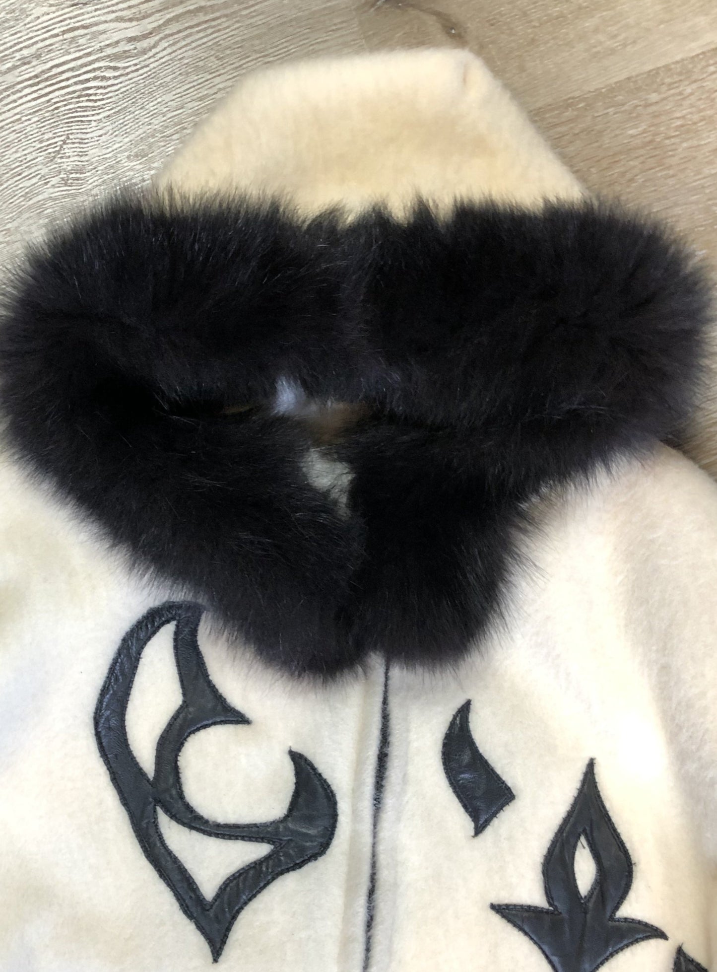 Kingspier Vintage - Linda Lundstrom full length black and white wool coat with fur hood, soft leather applique on the chest and back, zipper closures and a black satin like lining. Made in Canada.