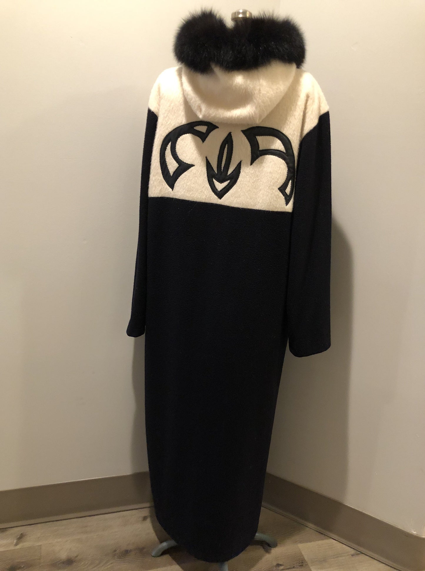 Kingspier Vintage - Linda Lundstrom full length black and white wool coat with fur hood, soft leather applique on the chest and back, zipper closures and a black satin like lining. Made in Canada.