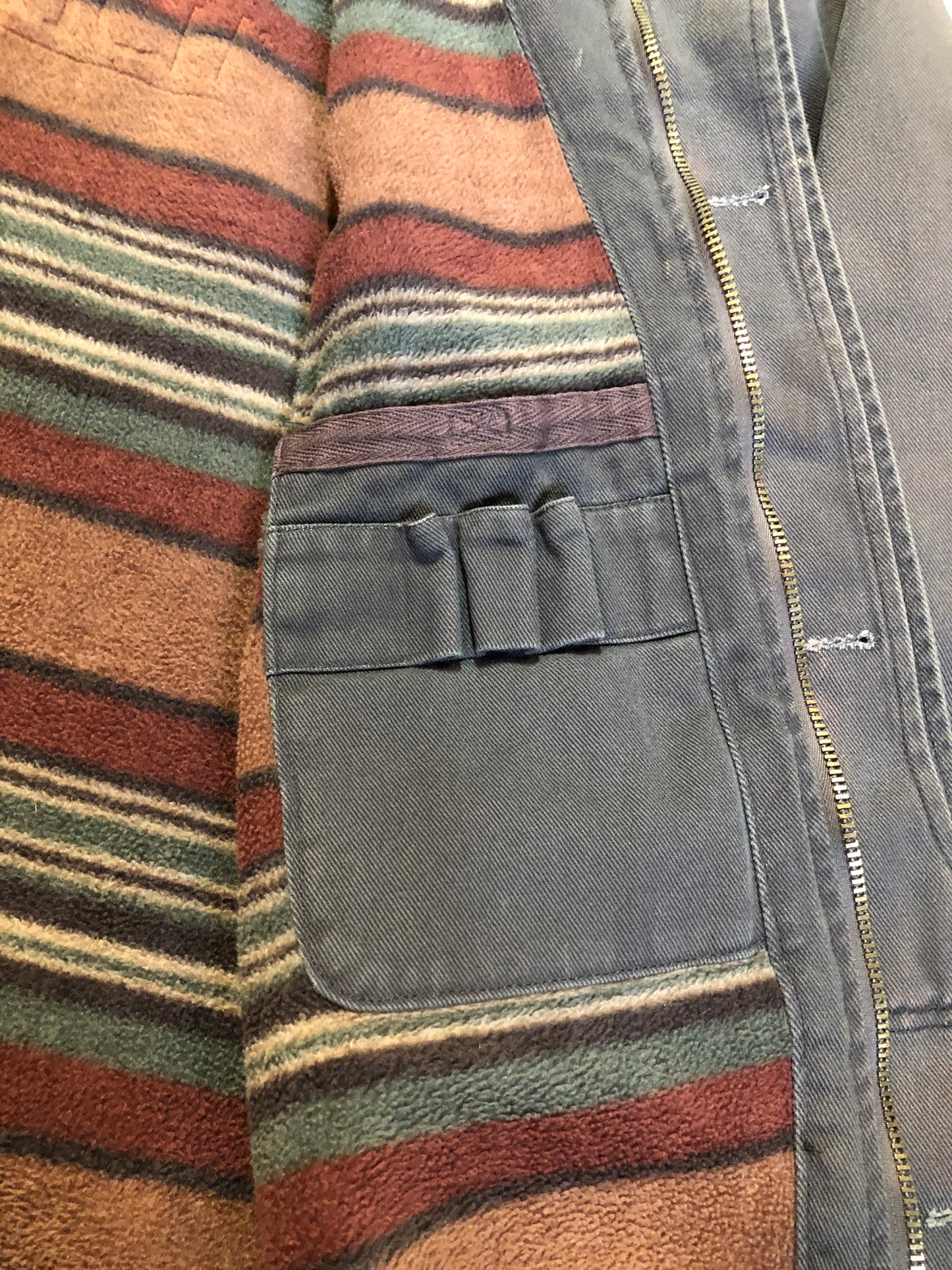 Kingspier Vintage - Woolrich olive green chore jacket features suede collar, flap pockets, hand warmer pockets, zipper and button closures, inside autumn colour striped fleece lining and inside pocket with pencil/ small tool holders. Men’s large.