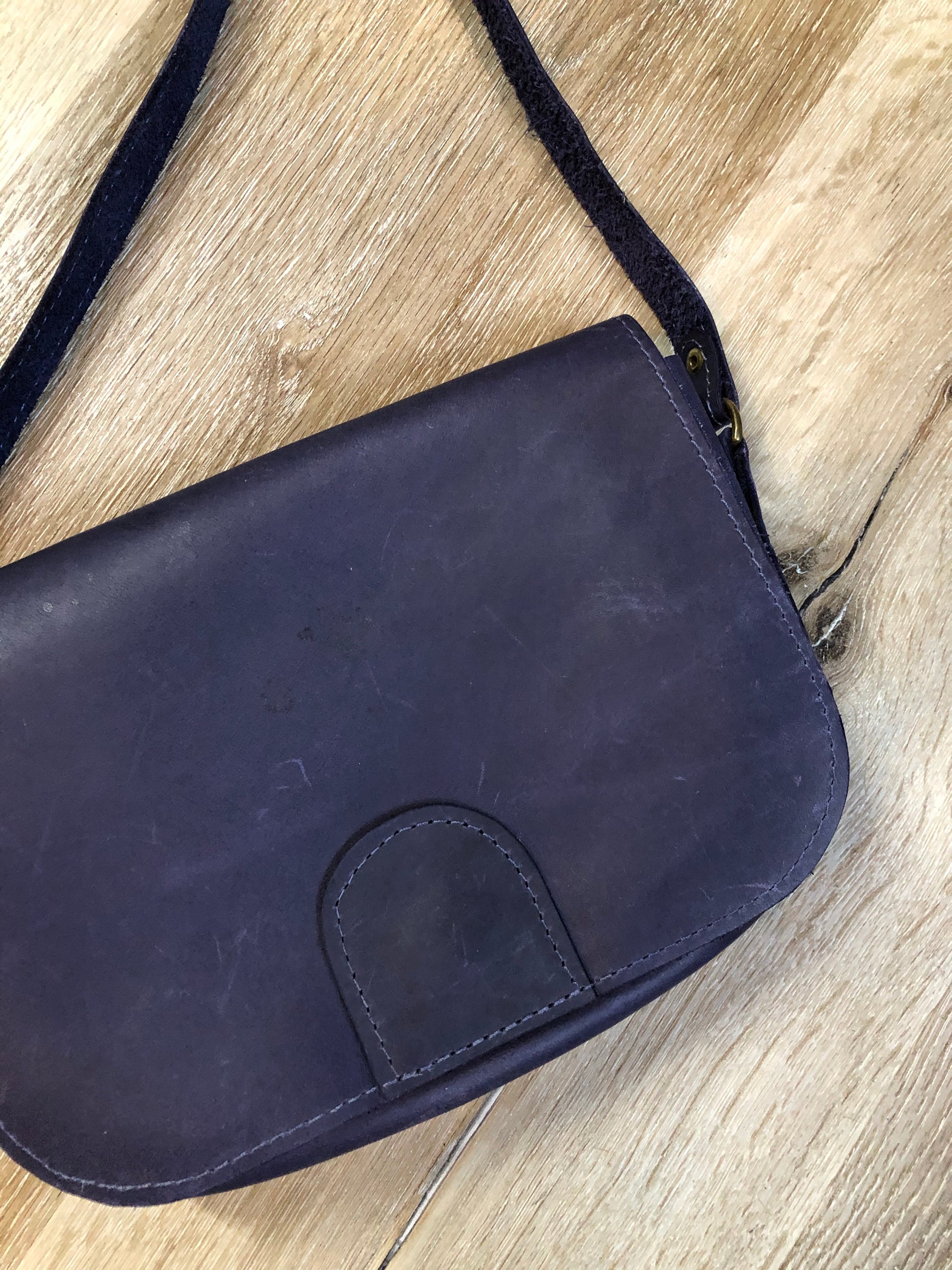 Kingspier Vintage - Purple leather crossbody bag with snap front closure and leather lining.
Length - 9”
Width - .2”
Height - 6”
Step - 51”
This purse is in great condition with some minor wear.