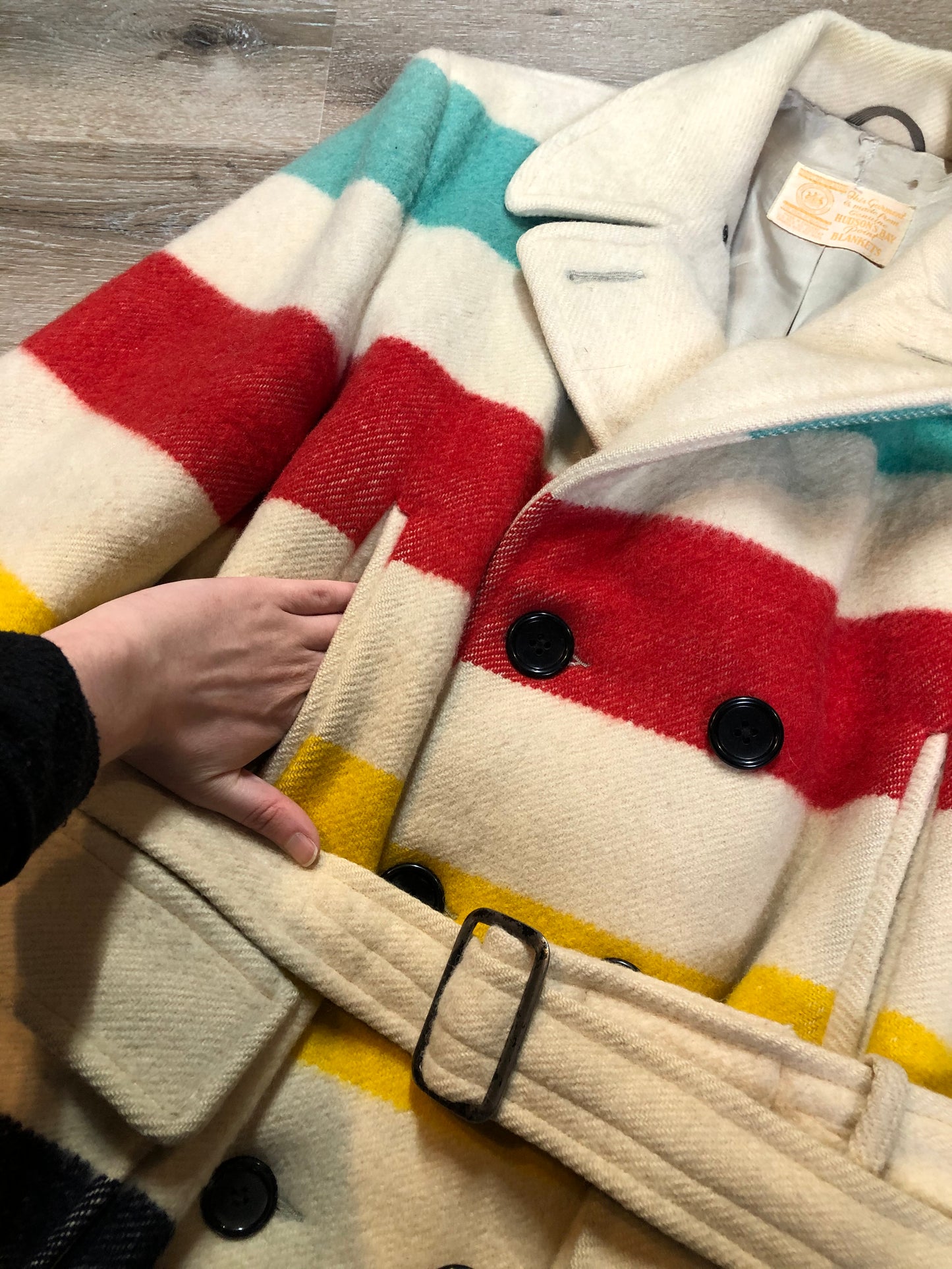 Kingspier Vintage - Genuine Hudson’s Bay Company point blanket coat in the iconic multi stripe colours. The coat features flap pockets and hand warmer pockets, double breasted button closures and belt. Made in Canada. Mens size 50.