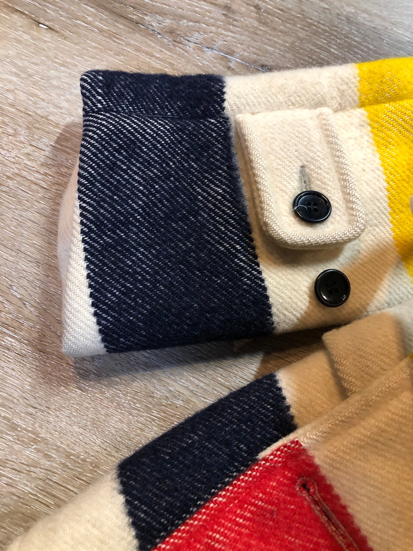 Kingspier Vintage - Genuine Hudson’s Bay Company point blanket coat in the iconic multi stripe colours. The coat features flap pockets and hand warmer pockets, double breasted button closures and belt. Made in Canada. Mens size 50.
