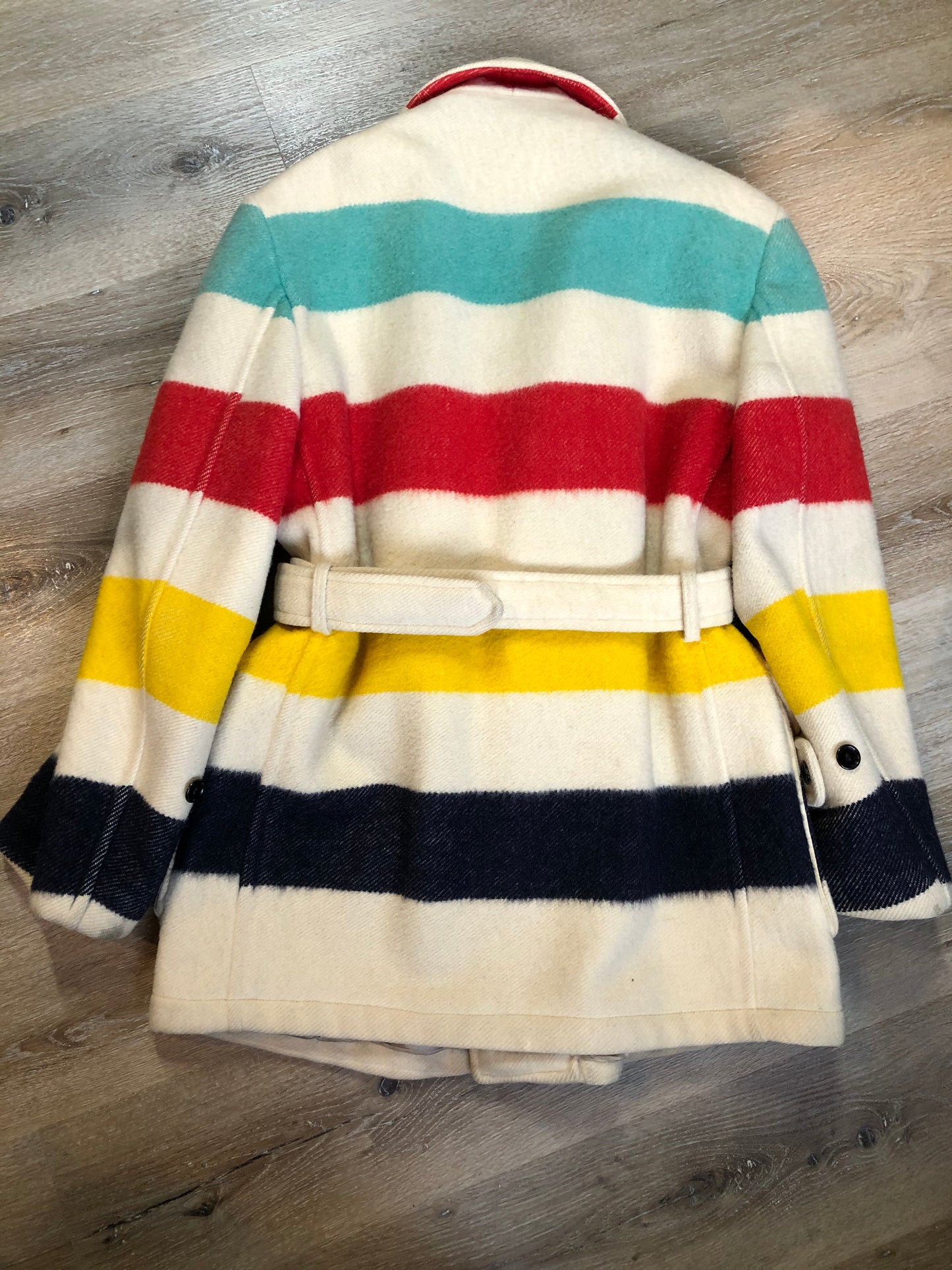 Kingspier Vintage - Genuine Hudson’s Bay Company point blanket coat in the iconic multi stripe colours. The coat features flap pockets and hand warmer pockets, double breasted button closures and belt. Made in Canada. Mens size 50.