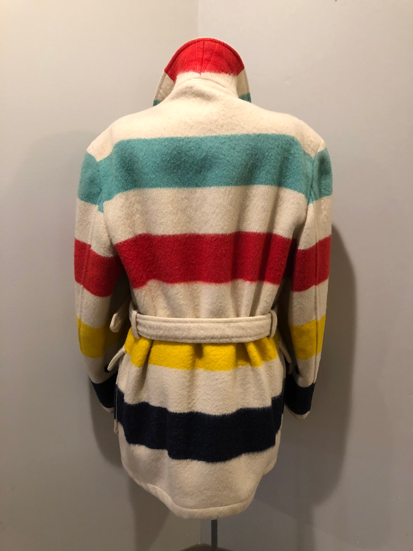 Kingspier Vintage - Genuine Hudson’s Bay Company point blanket coat in the iconic multi stripe colours. The coat features flap pockets and hand warmer pockets, double breasted button closures and belt. Made in Canada. Mens size 50.