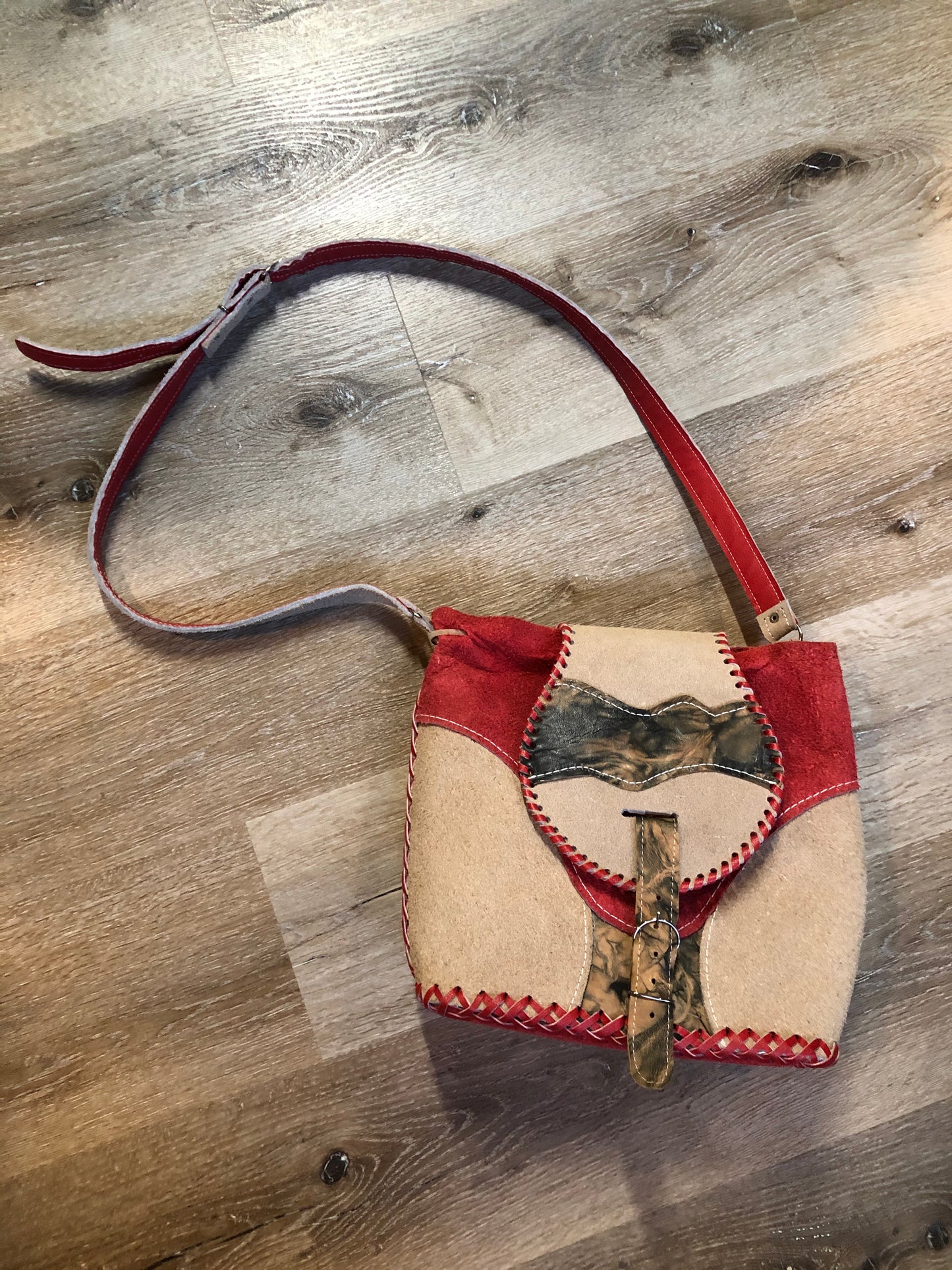 Kingspier Vintage - Tan and red saddle bag with red leather stitching, one large inside compartment and an adjustable shoulder strap.