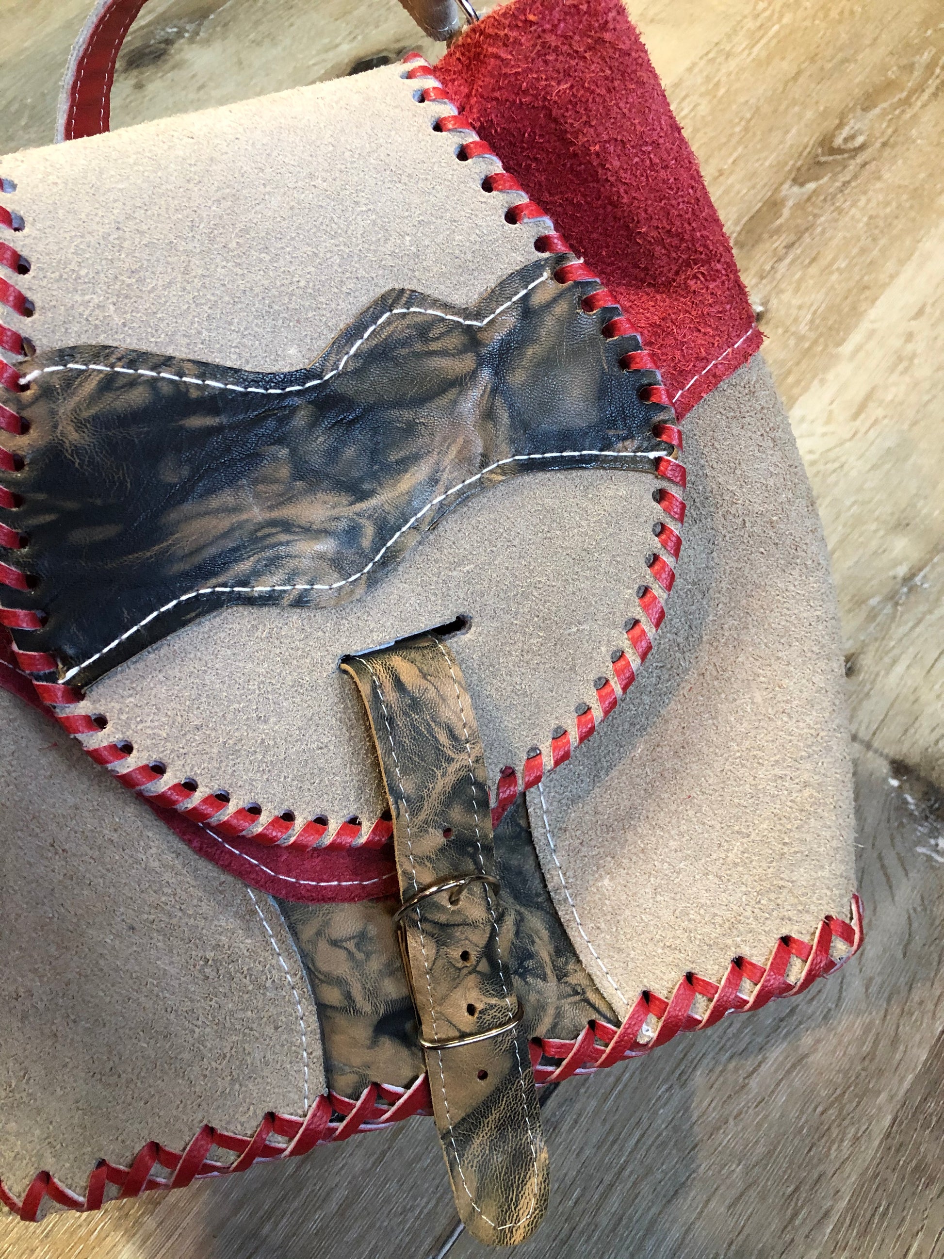 Kingspier Vintage - Tan and red saddle bag with red leather stitching, one large inside compartment and an adjustable shoulder strap.