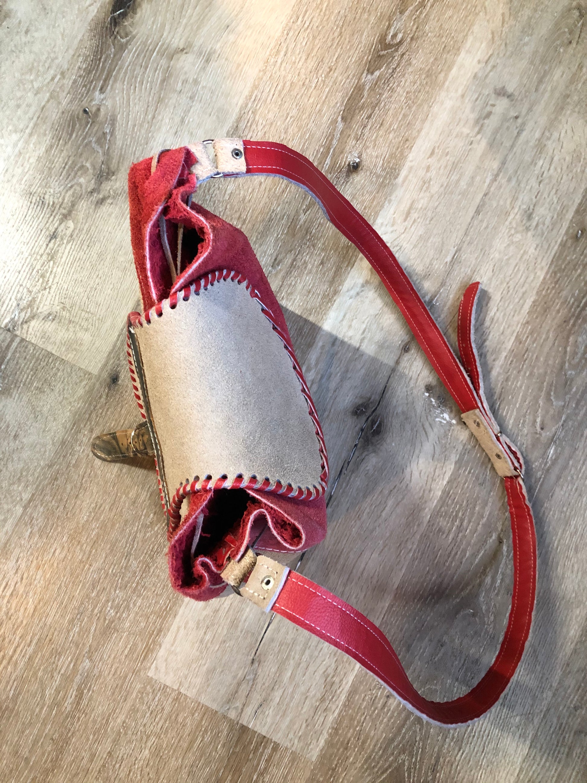 Kingspier Vintage - Tan and red saddle bag with red leather stitching, one large inside compartment and an adjustable shoulder strap.