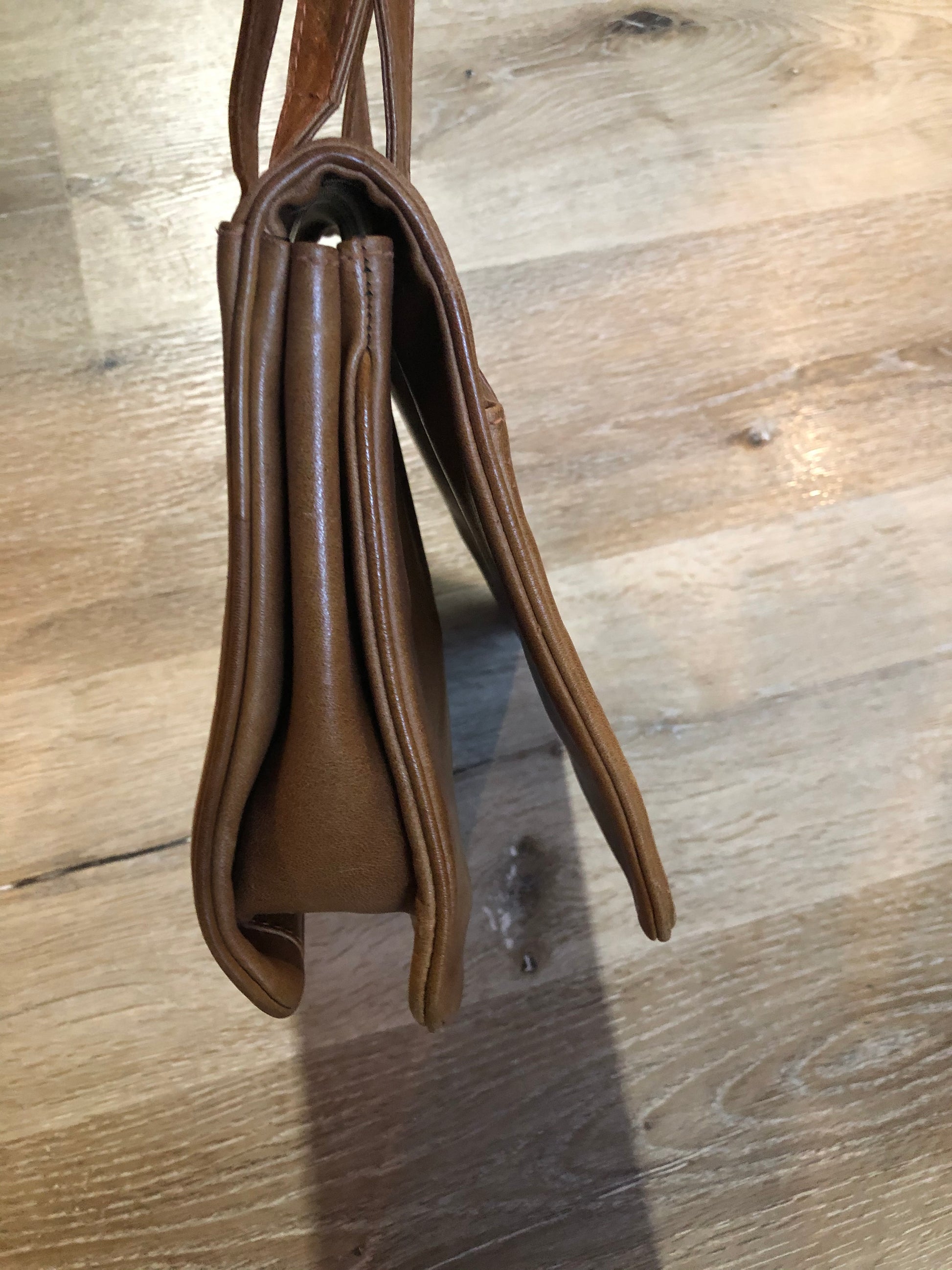 Kingspier Vintage - Jordan Marsh tan leather handbag with gold hardware and three inside compartments.