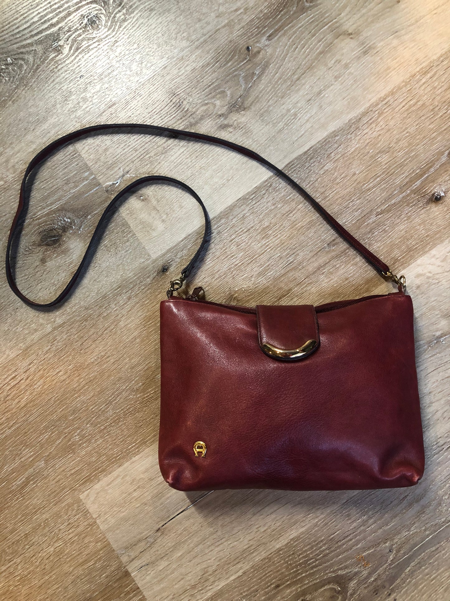 Kingspier Vintage - Etienne Aigner leather crossbody bag with brass hardware, zipper top closure and snap front closure.