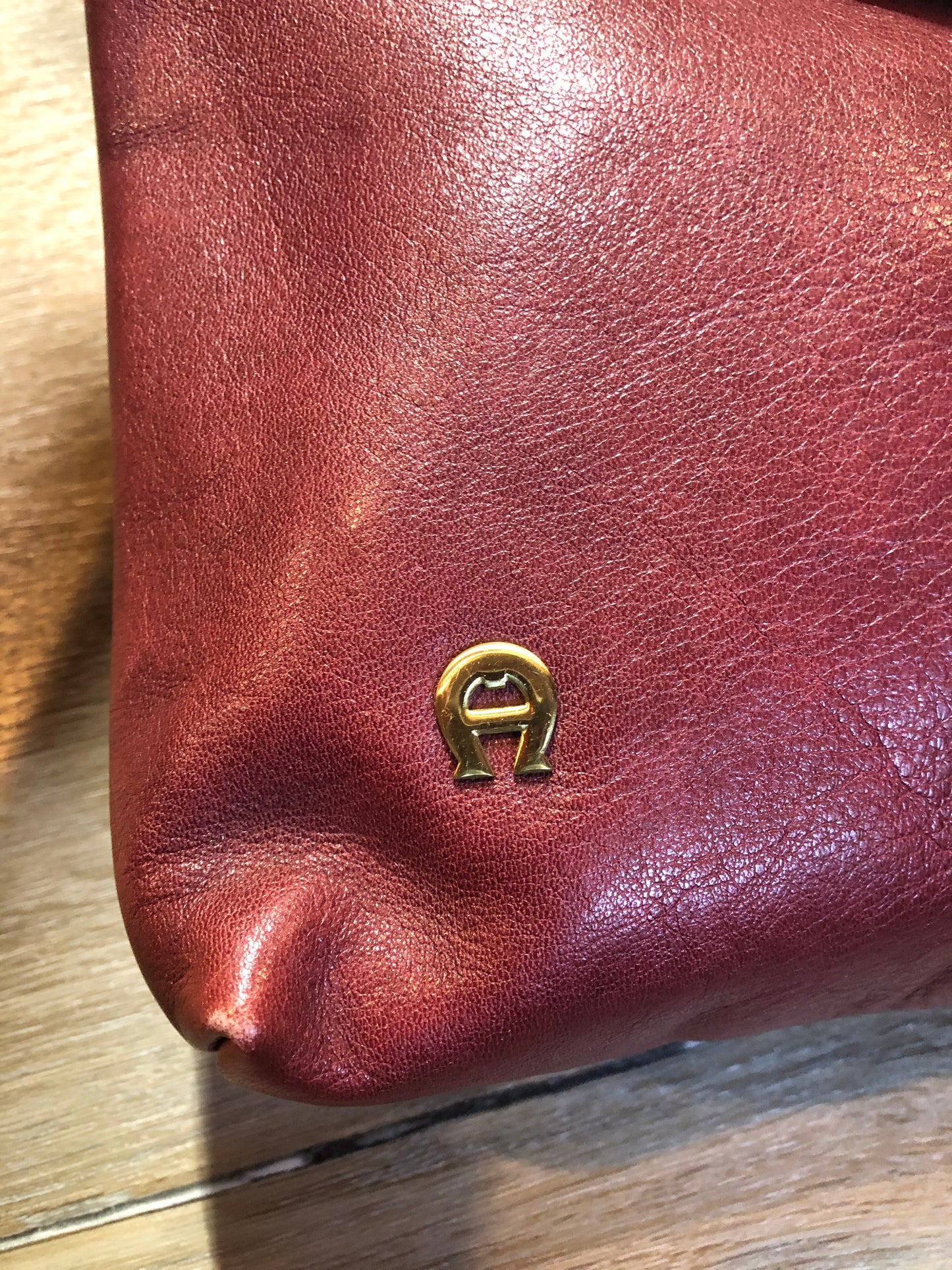 Kingspier Vintage - Etienne Aigner leather crossbody bag with brass hardware, zipper top closure and snap front closure.