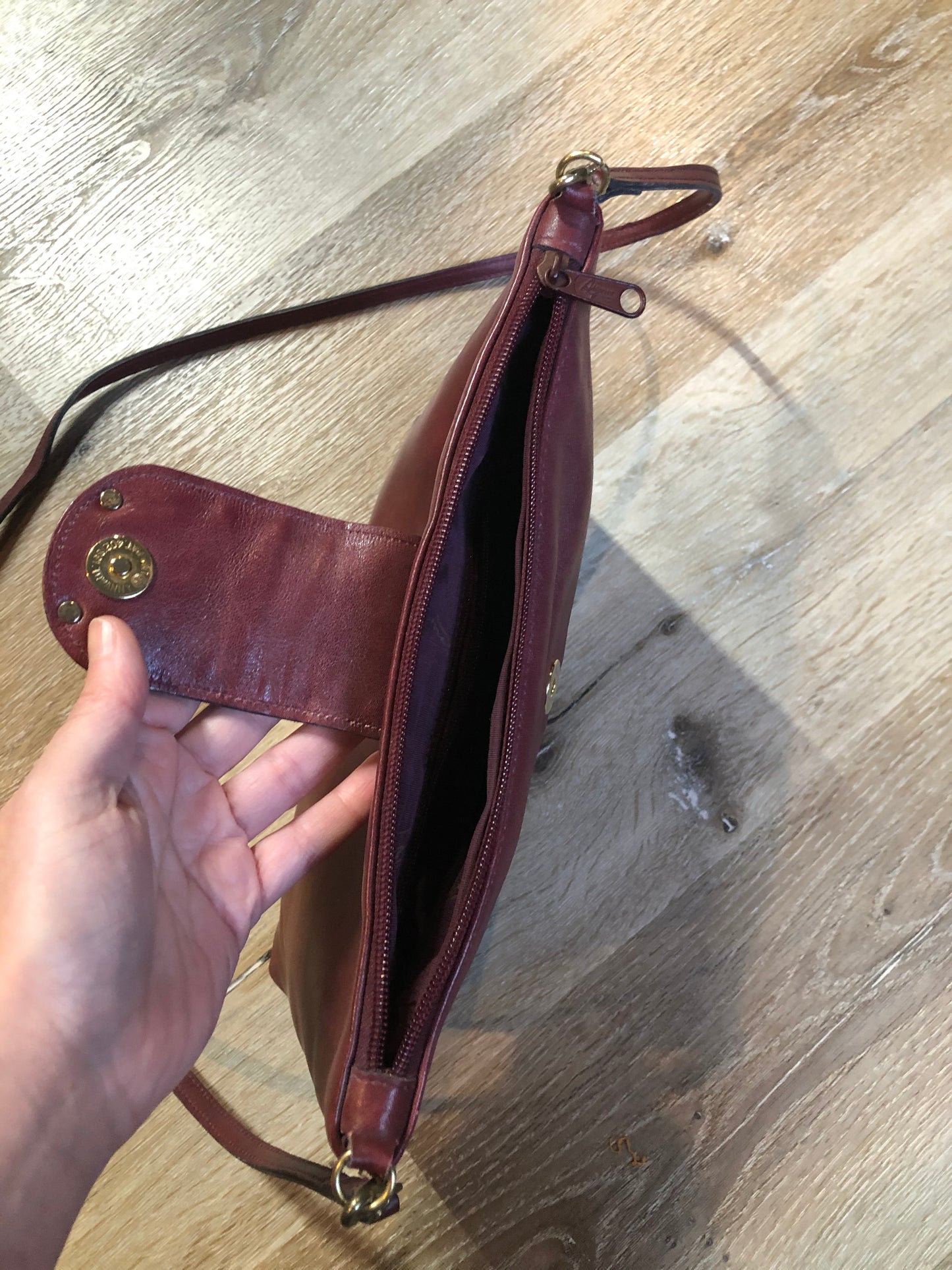 Kingspier Vintage - Etienne Aigner leather crossbody bag with brass hardware, zipper top closure and snap front closure.