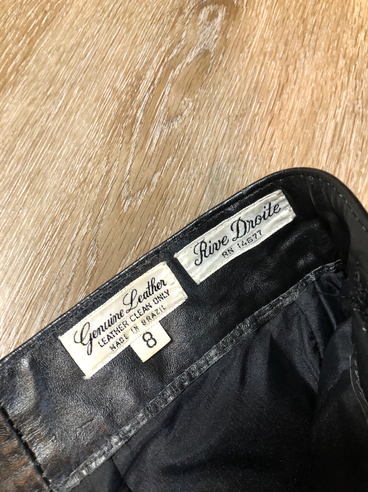 Kingspier Vintage - Rive Droite blsck leather highrise pants with tapered leg, zip side pockets and belt detail. Size 12