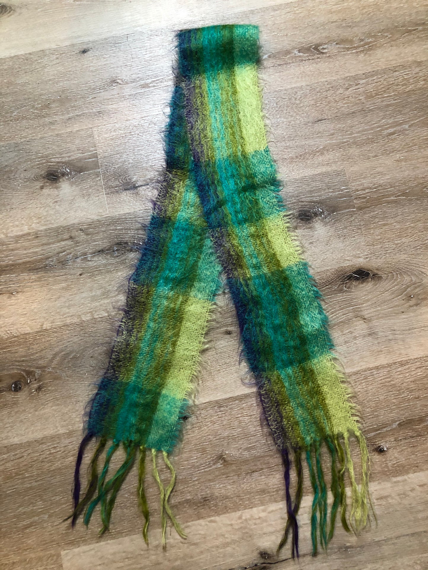Kingspier Vintage - Handmade green, teal and purple plaid scarf.
Length - 70”
Width - 6”
Scarf is in excellent condition.