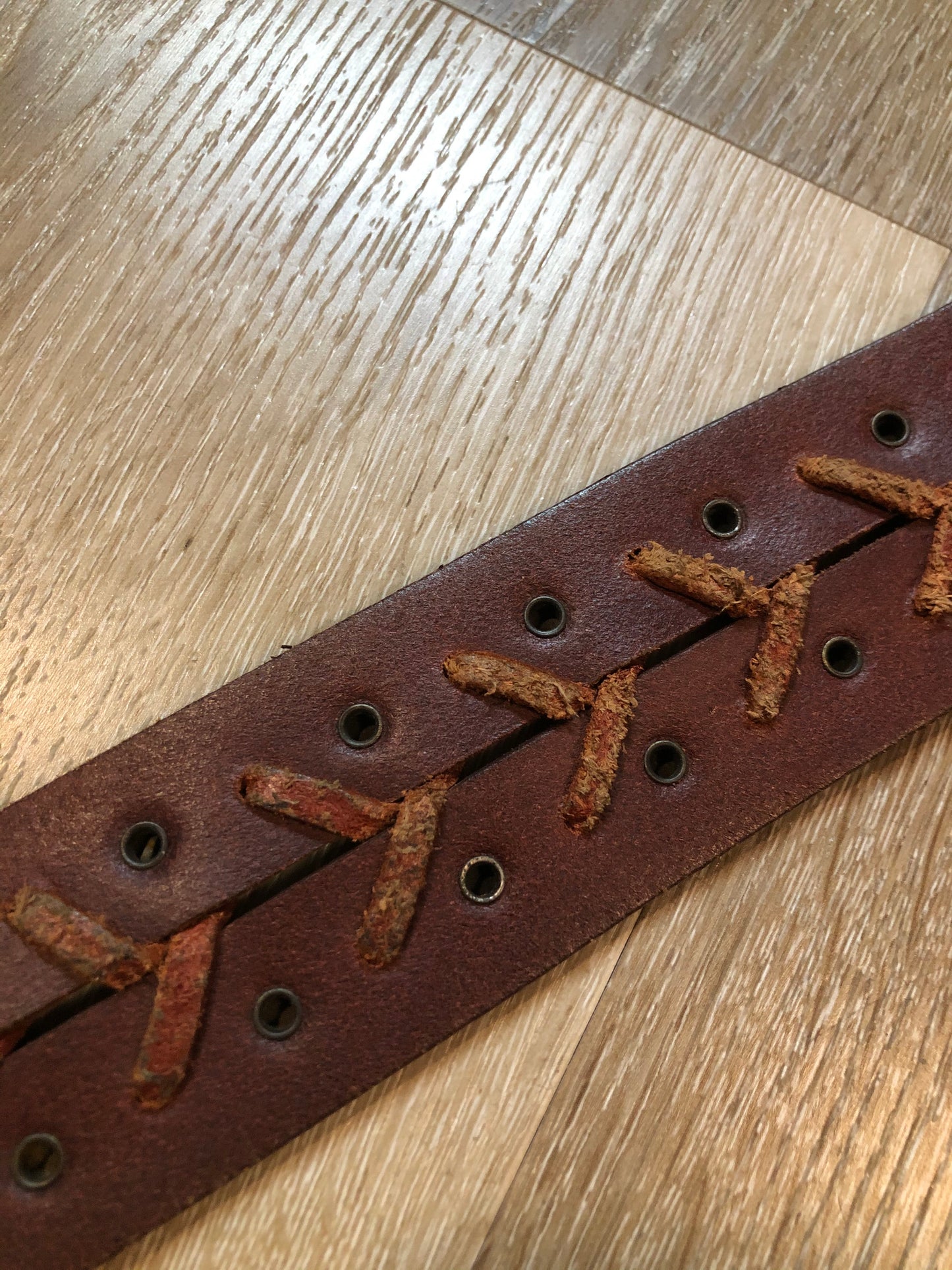 Kingspier Vintage - Brown leather belt with decorative leather stitching and brass circle buckle.