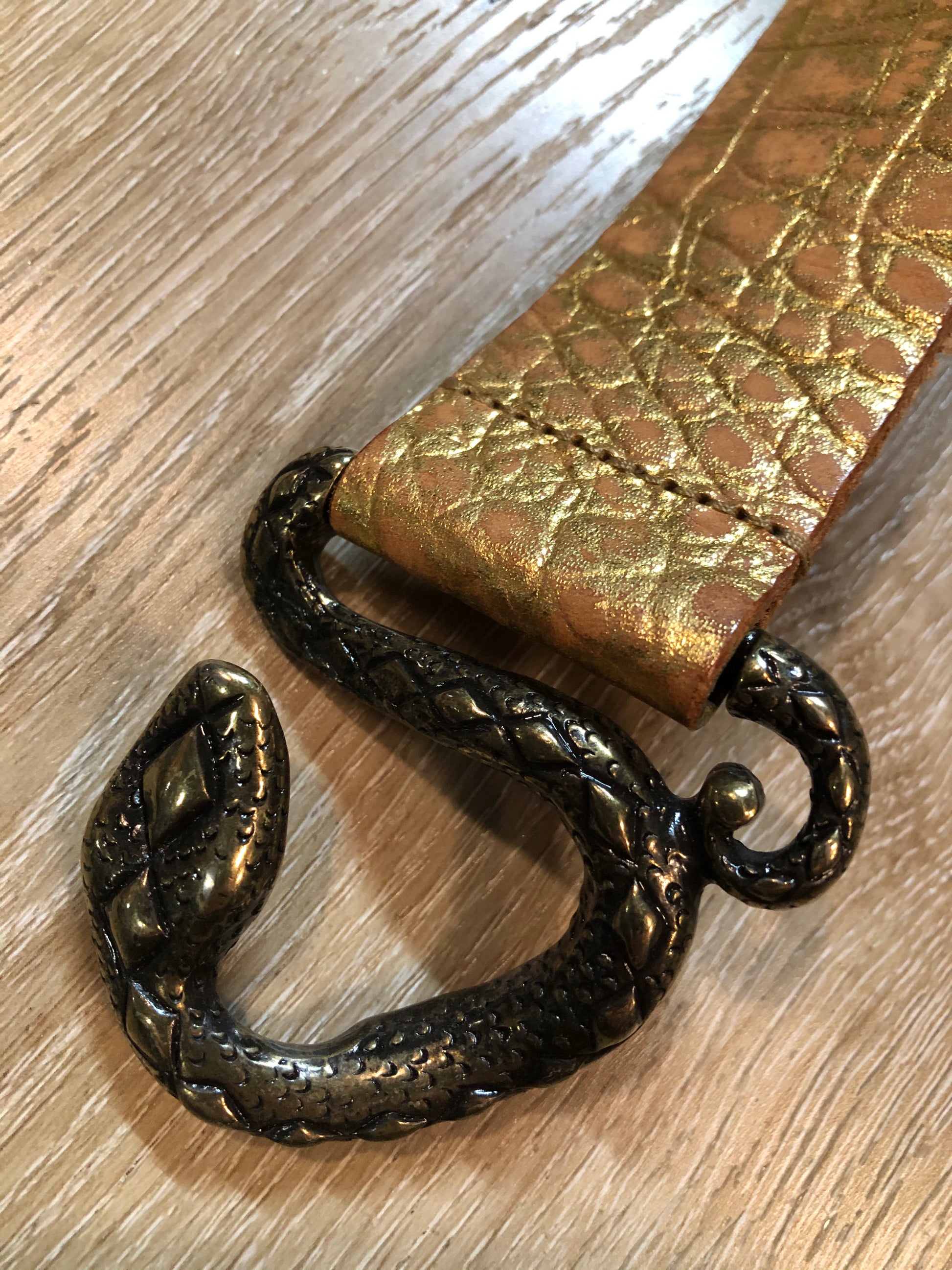 Kingspier Vintage - Gold croc-embossed leather belt with snake buckle closure.