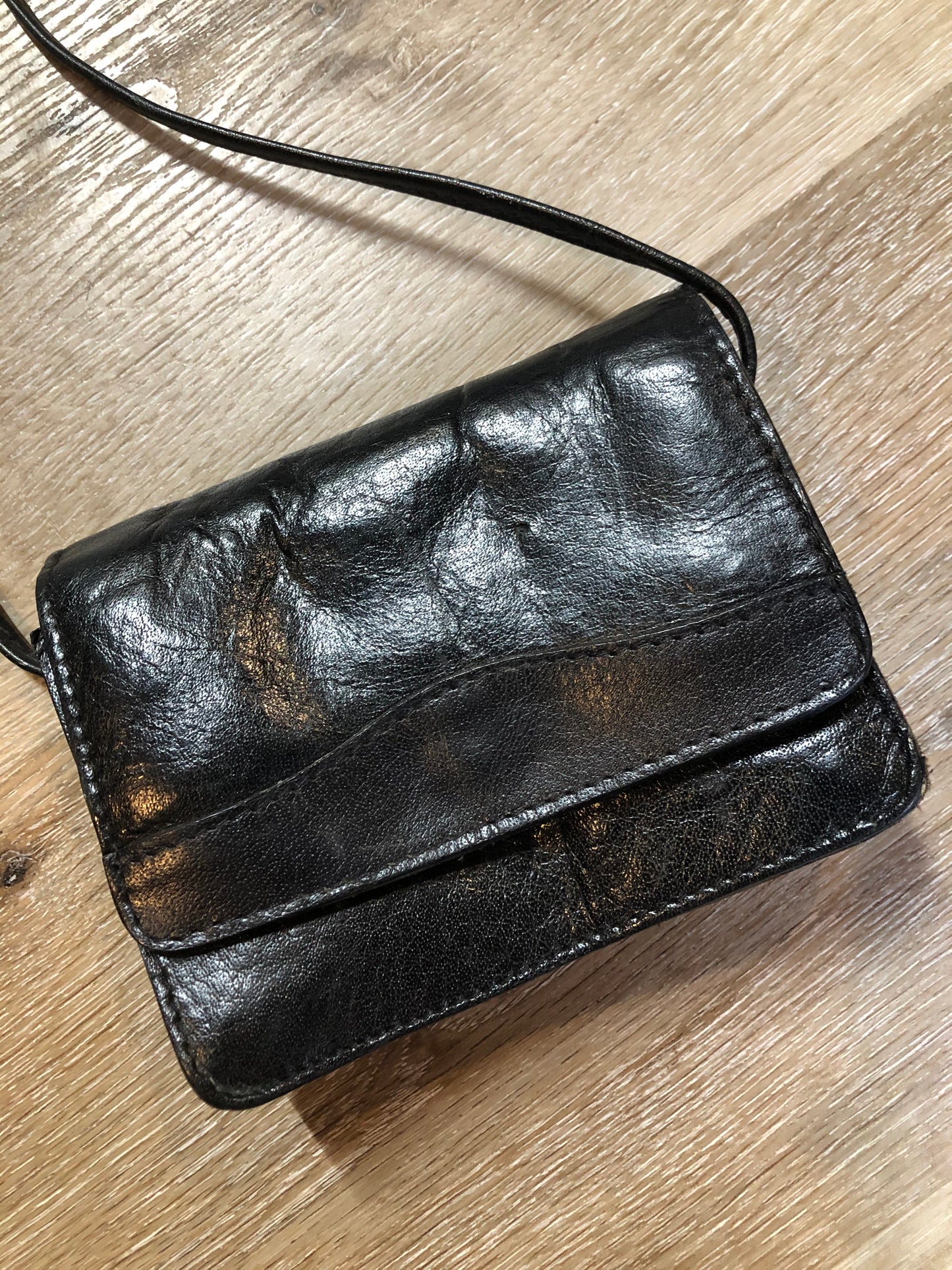 Kingspier Vintage - Small black leather crossbody bag with skinny strap, snap closure, loop to attach to a belt and a paisley lining.