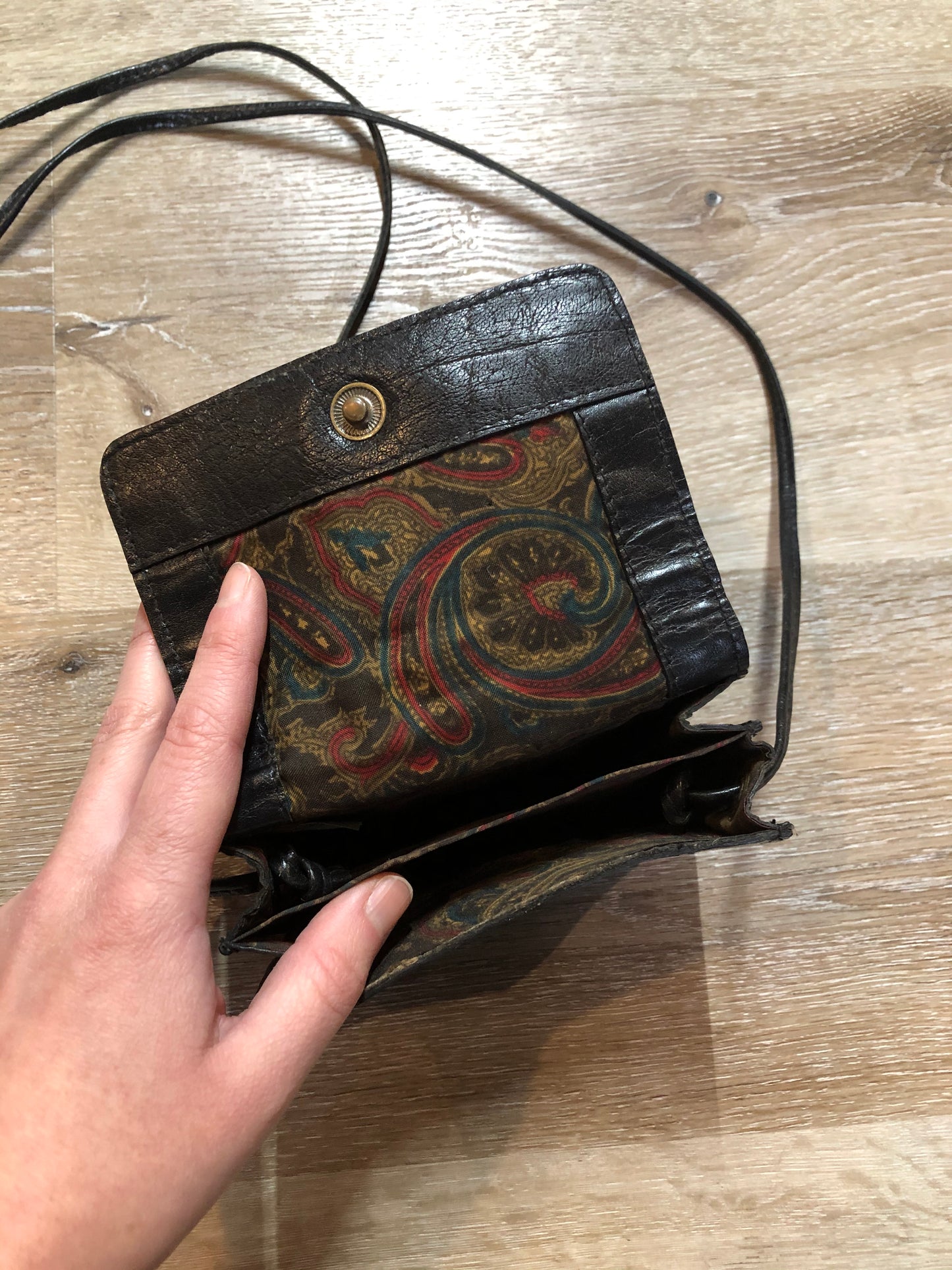 Kingspier Vintage - Small black leather crossbody bag with skinny strap, snap closure, loop to attach to a belt and a paisley lining.