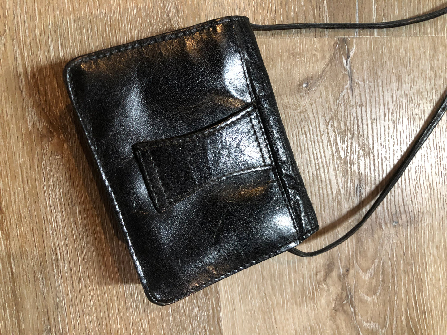 Kingspier Vintage - Small black leather crossbody bag with skinny strap, snap closure, loop to attach to a belt and a paisley lining.