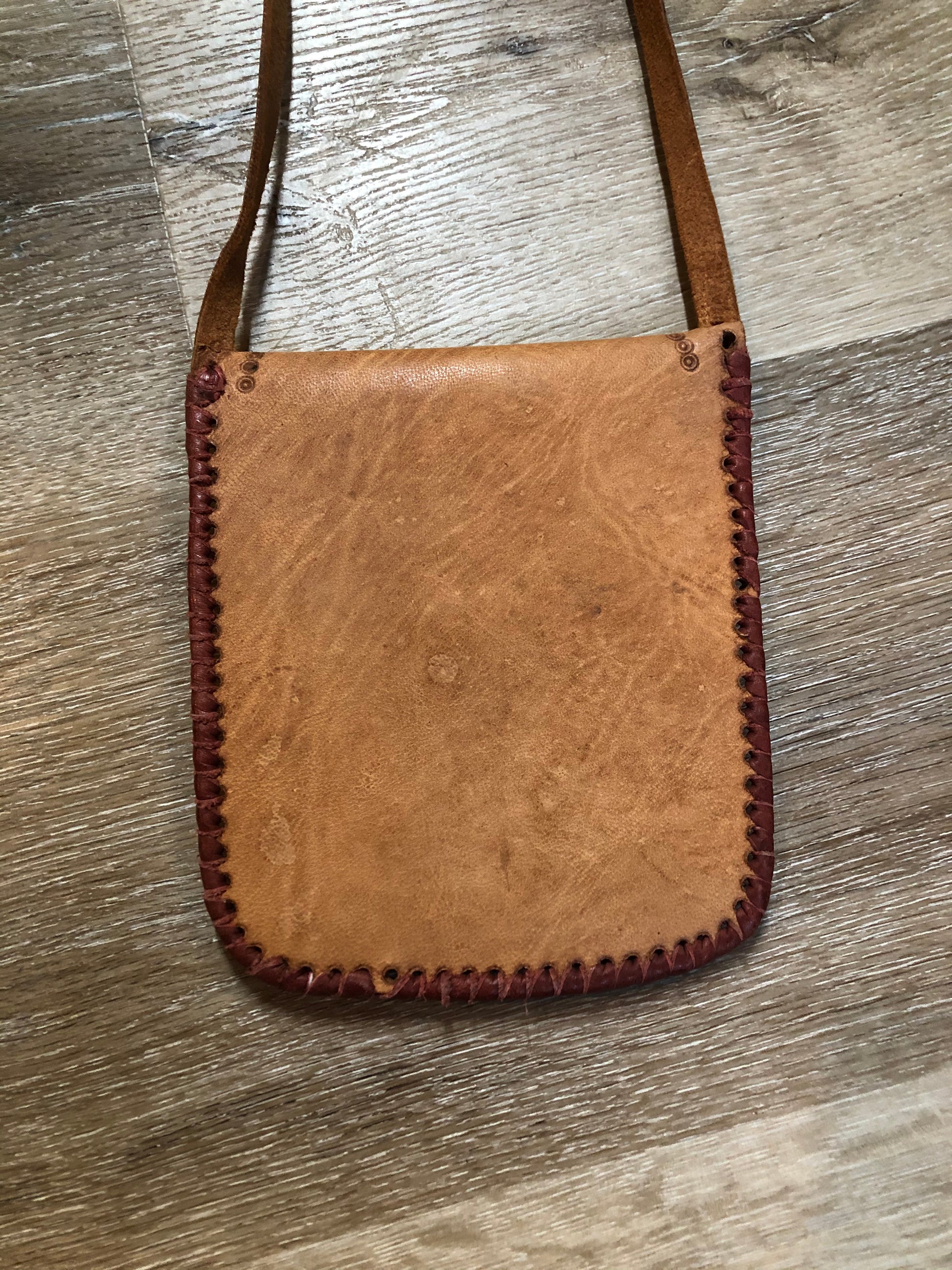 Kingspier Vintage - Small tan leather crossbody pouch with snap front closure, leather stitching and decorative tooling.