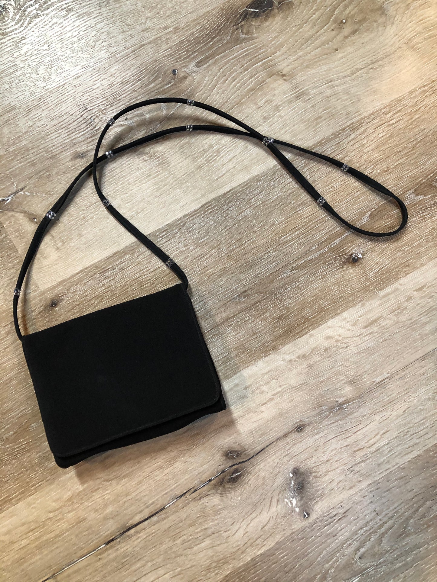 Kingspier Vintage - Stuart Weitzman for Russell and Bromley black crossbody bag with sparkle details on the strap, flap top with snap closure. Fibre content unknown.