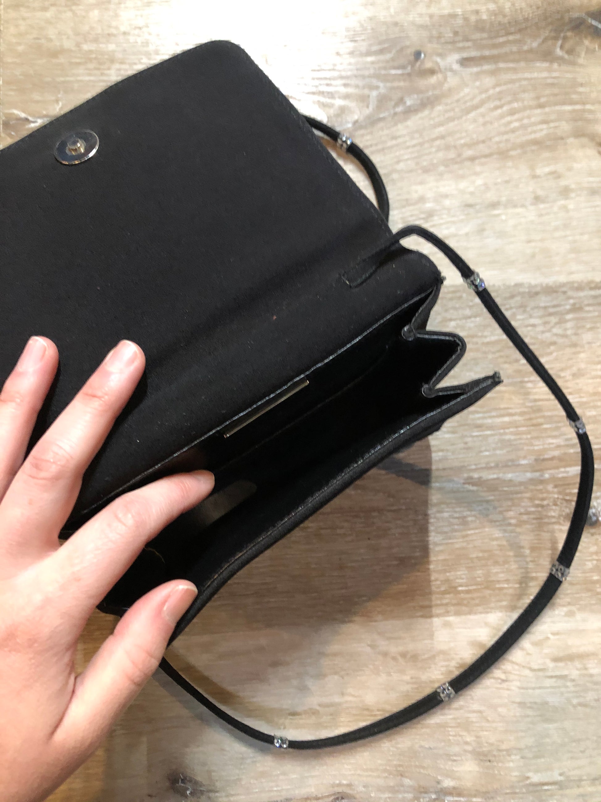 Kingspier Vintage - Stuart Weitzman for Russell and Bromley black crossbody bag with sparkle details on the strap, flap top with snap closure. Fibre content unknown.