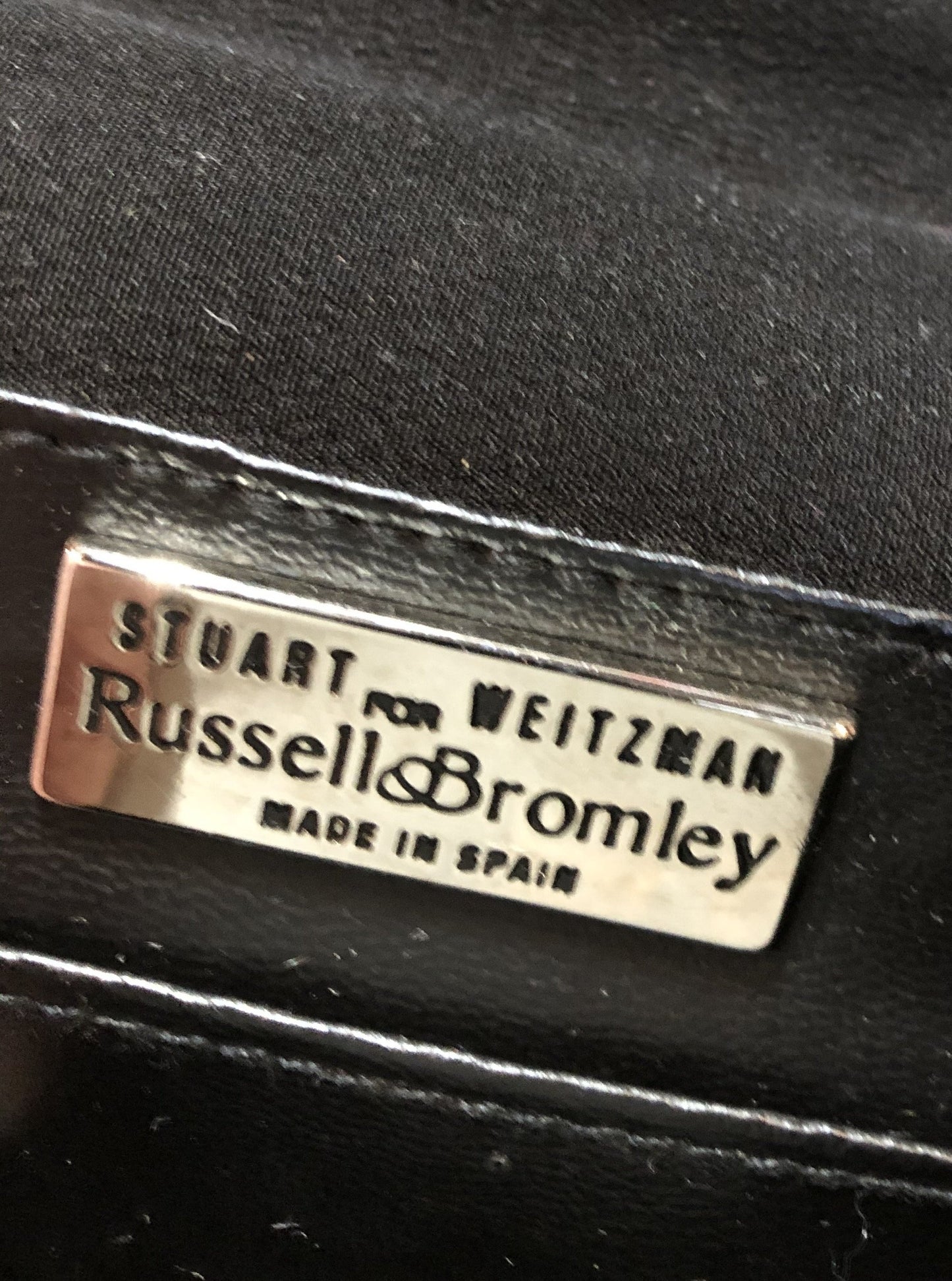 Kingspier Vintage - Stuart Weitzman for Russell and Bromley black crossbody bag with sparkle details on the strap, flap top with snap closure. Fibre content unknown.