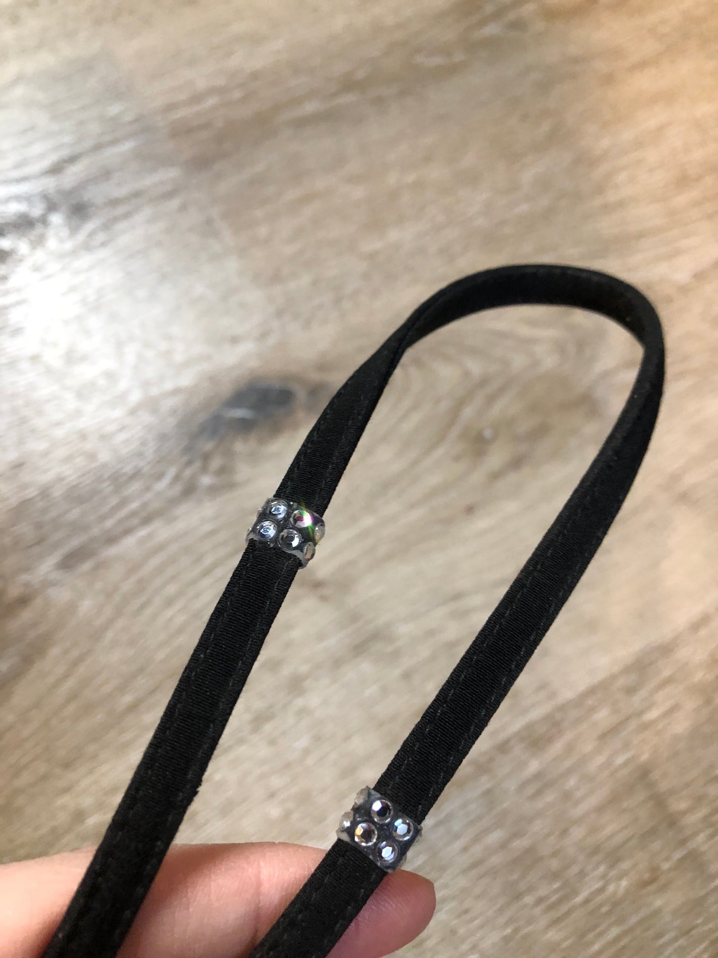 Kingspier Vintage - Stuart Weitzman for Russell and Bromley black crossbody bag with sparkle details on the strap, flap top with snap closure. Fibre content unknown.