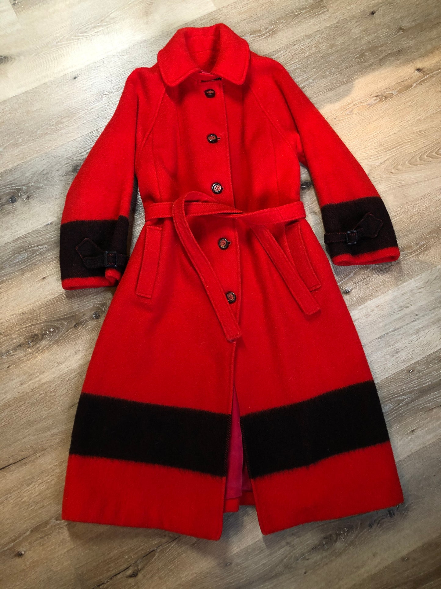 Kingspier Vintage - Hudson’s Bay Company red and black stripe 100% virgin wool point blanket coat in a swing coat style with belt, buckle detail at the collar, button closures, slash pockets and red lining. Size medium/ large.