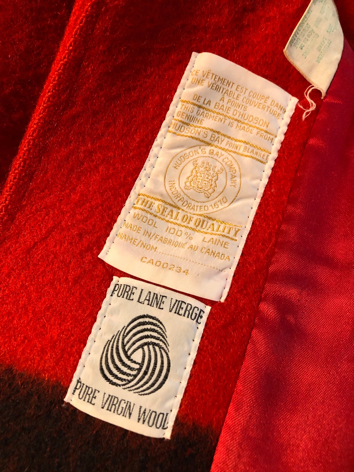 Kingspier Vintage - Hudson’s Bay Company red and black stripe 100% virgin wool point blanket coat in a swing coat style with belt, buckle detail at the collar, button closures, slash pockets and red lining. Size medium/ large.