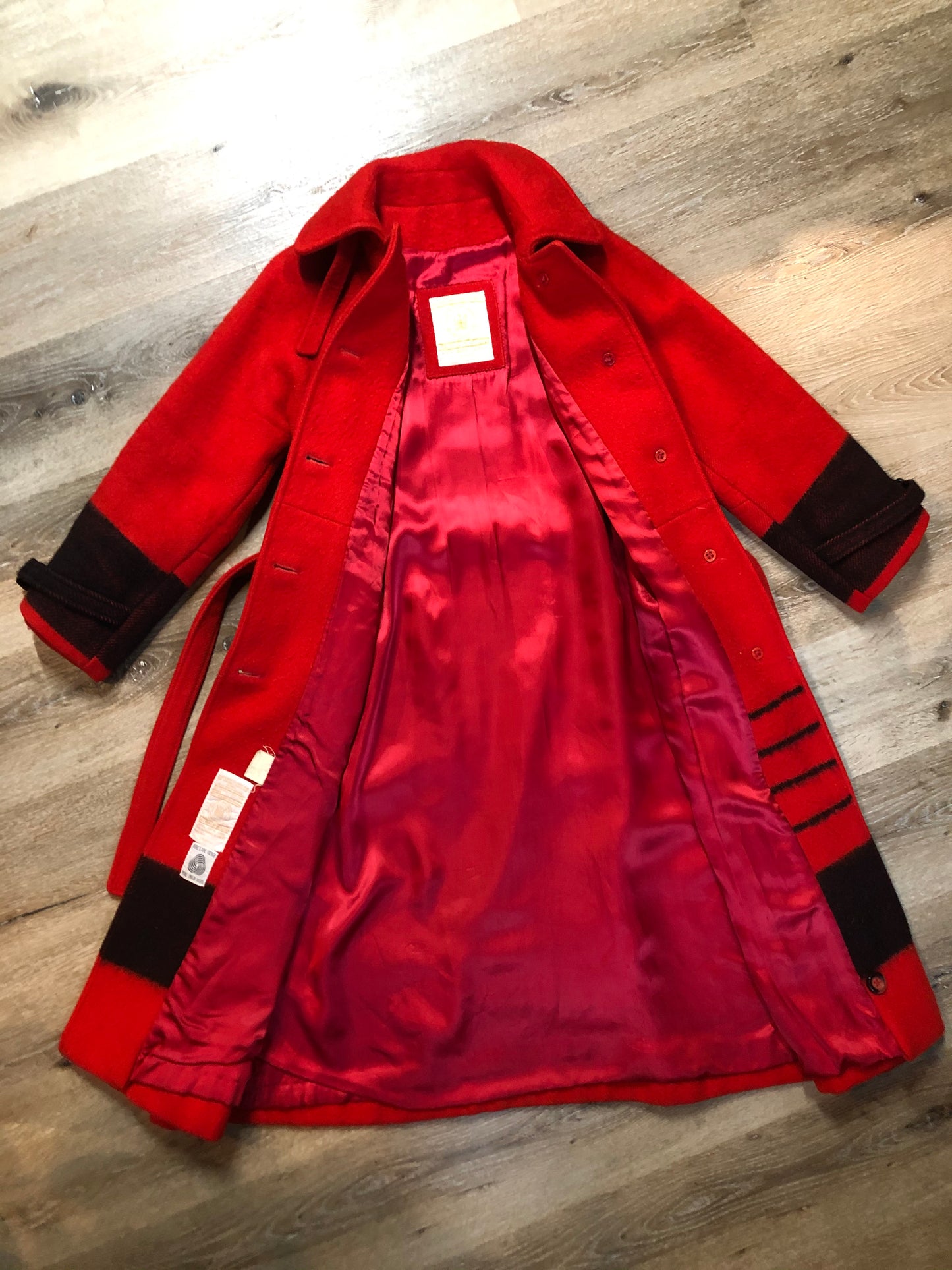 Kingspier Vintage - Hudson’s Bay Company red and black stripe 100% virgin wool point blanket coat in a swing coat style with belt, buckle detail at the collar, button closures, slash pockets and red lining. Size medium/ large.