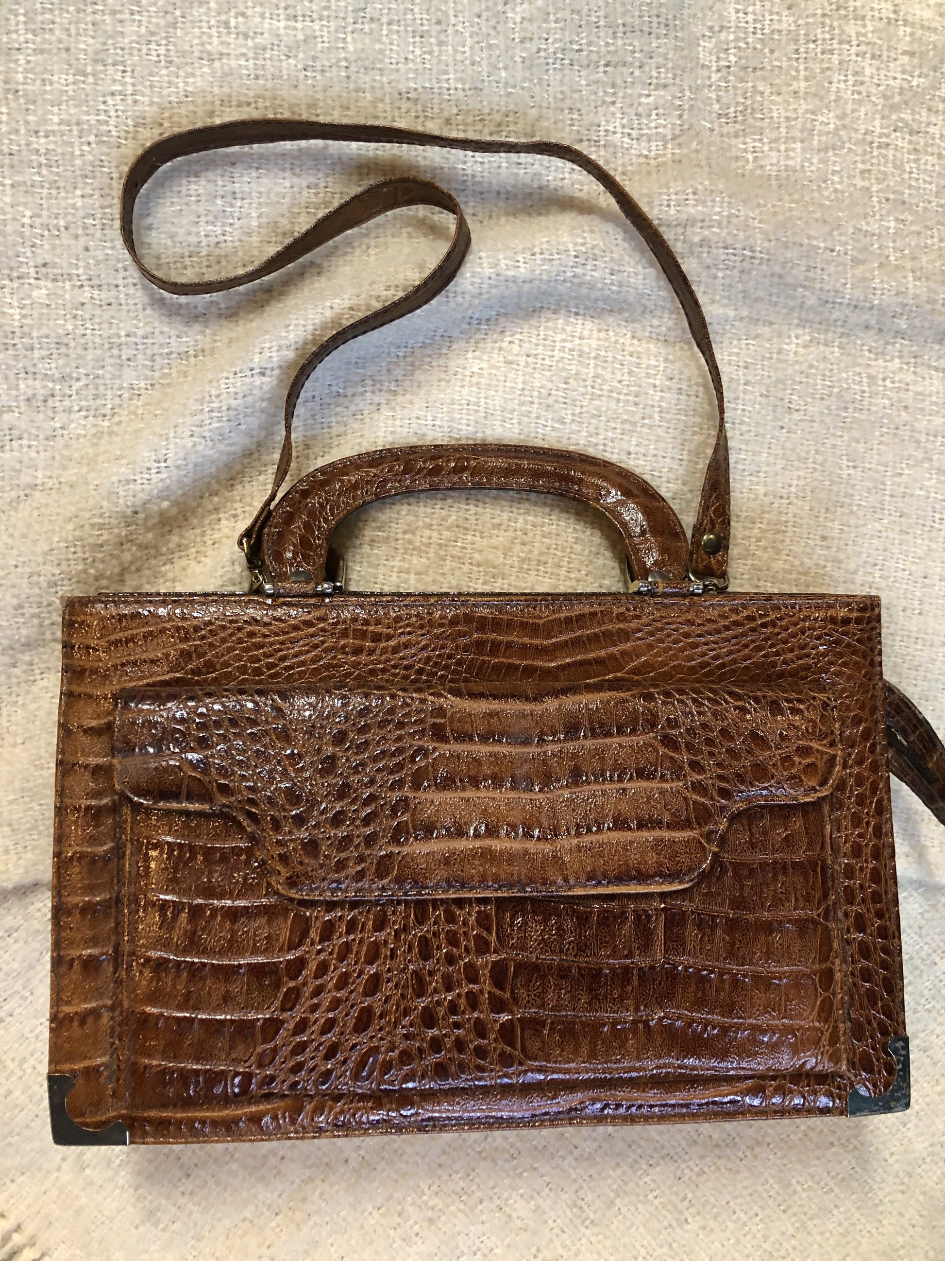 Kingspier Vintage - Vintage Veneto reptile skin satchel with front pocket, removable shoulder strap and two large inside compartments. Made in Italy.
Length - 14”
Width - 3.5”
Height - 9”
Strap - 33”
This purse is in excellent condition.