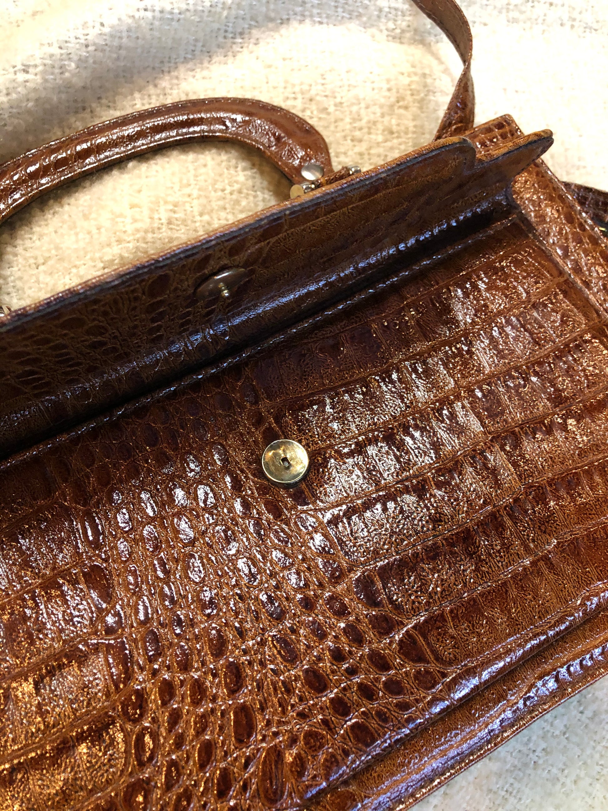 Kingspier Vintage - Vintage Veneto reptile skin satchel with front pocket, removable shoulder strap and two large inside compartments. Made in Italy.
Length - 14”
Width - 3.5”
Height - 9”
Strap - 33”
This purse is in excellent condition.