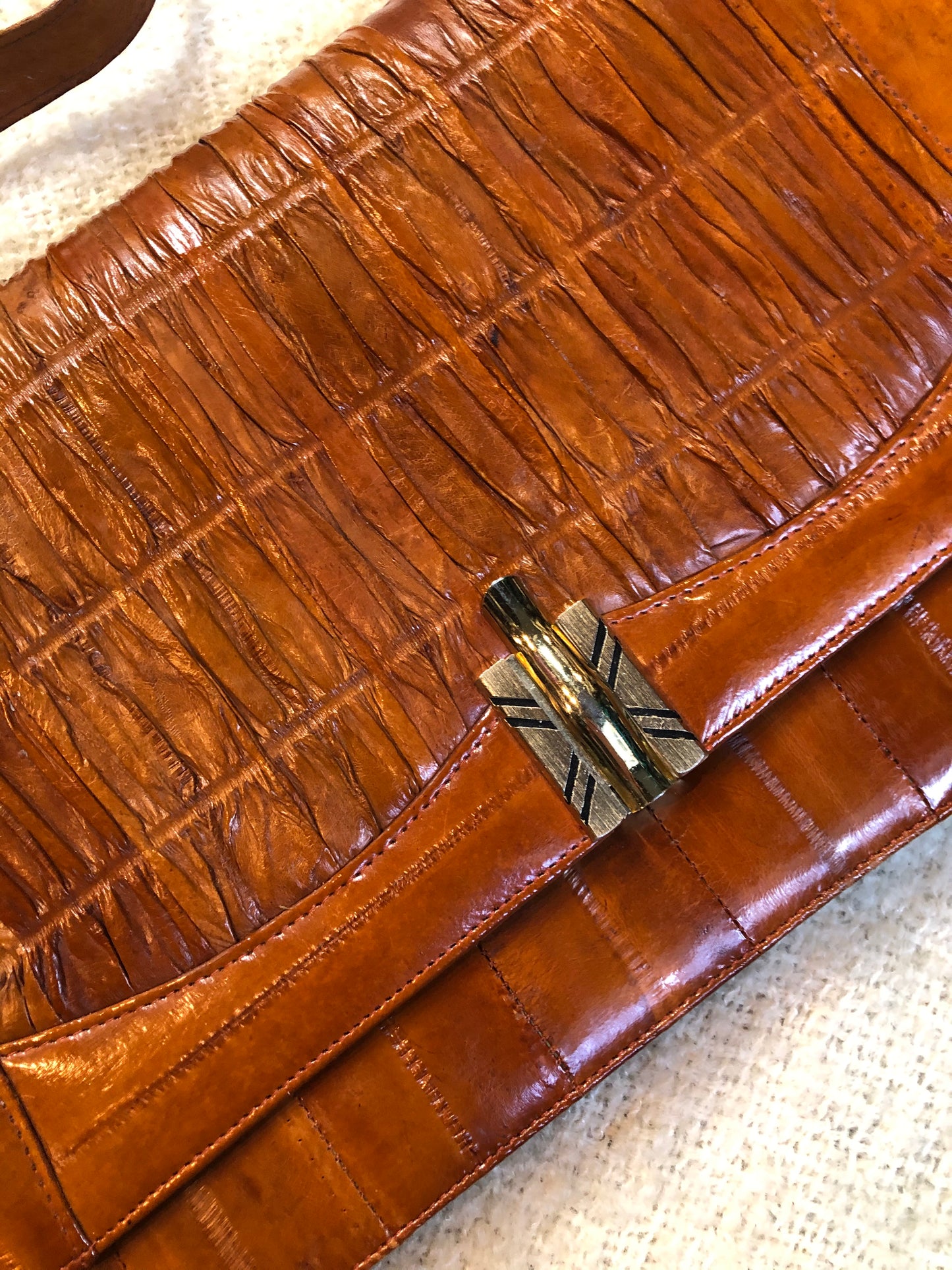 Kingspier Vintage - Vintage satchel in very soft caramel colour leather with gathered leather details, a unique front clasp, brass hardware and three inside compartments. 
Length - 12”
Width - 1”
Height - 7.5”
Strap - 30.5”
This purse is in excellent condition.